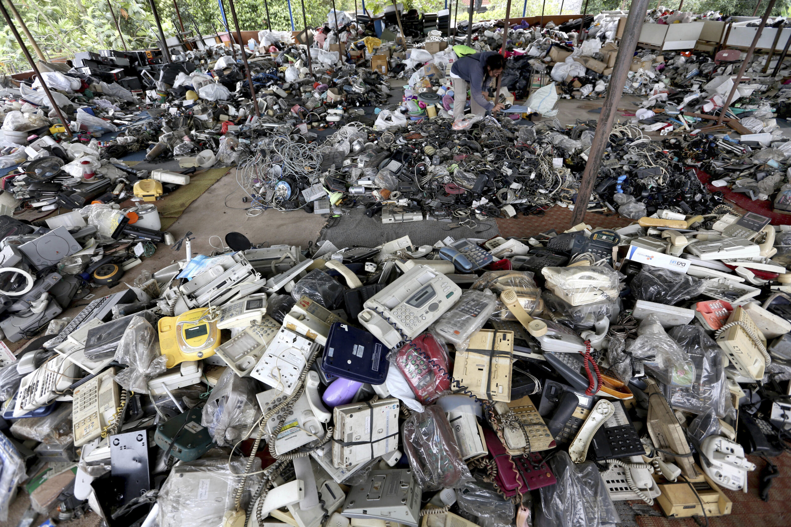 In this Friday, Jan. 13, 2017 photo, a customer browses through used items at a flea market on the outskirts of Jakarta, Indonesia. The waste from discarded electronic gadgets and electrical appliances has increased by two-thirds in East Asia over five years, posing a growing threat to health and the environment unless proper disposal becomes the norm. The United Nations University says China is the biggest culprit with its electronic waste more than doubling. (AP Photo/Tatan Syuflana) (AP)