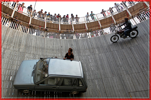 Stunt performers ride a motorcycle and a car on the walls of the "Well of Death" at the Magh Mela fair in Allahabad, India, January 18, 2017. REUTERS/Jitendra Prakash      TPX IMAGES OF THE DAY - RTSW23C (Reuters)