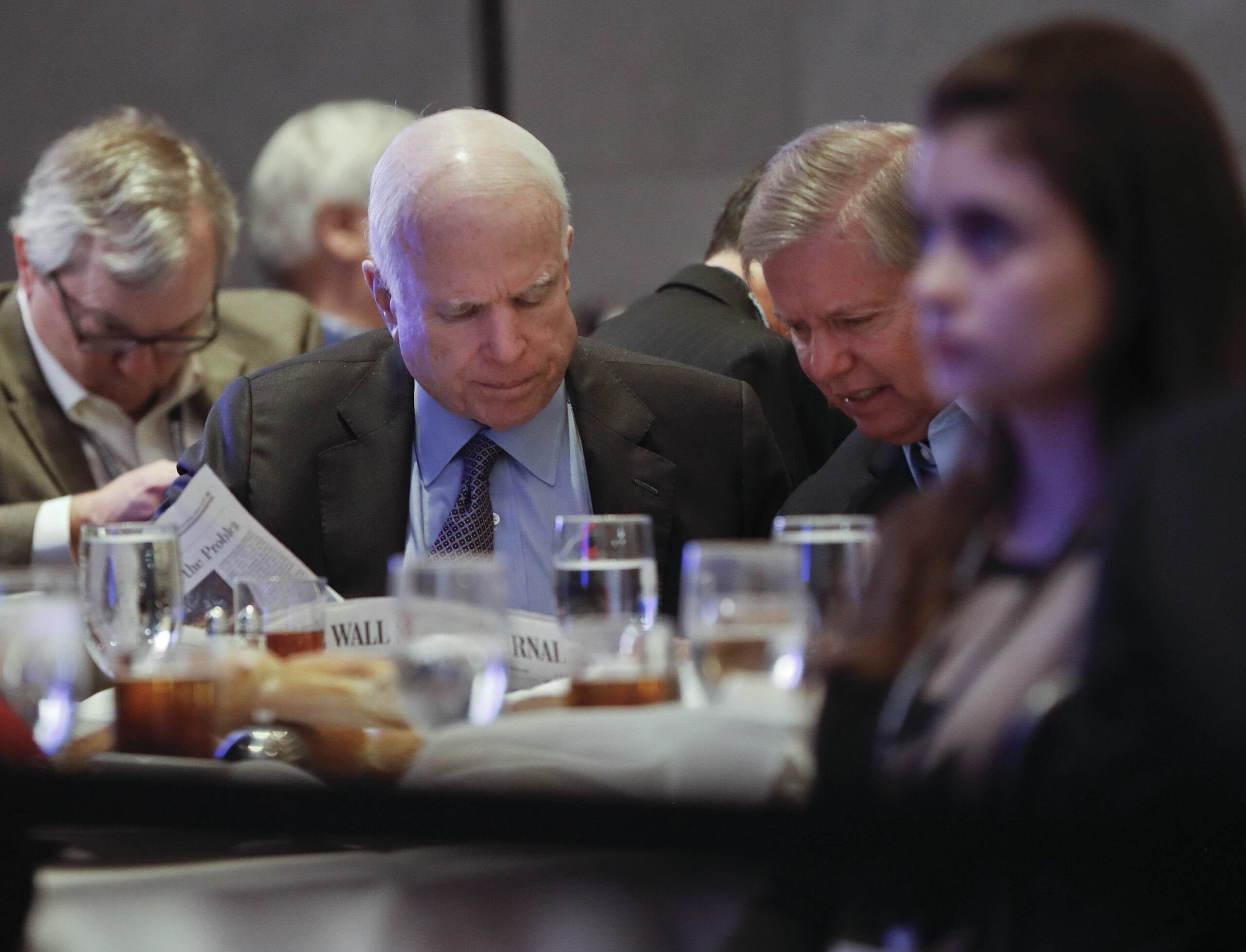 In this Jan. 26, 2017, photo, Sen. John McCain, R-Ariz., left, and Sen. Lindsey Graham, R-S.C., right, read the Wall Street Journal newspaper as they wait for President Donald Trump to speak at the House and Senate GOP lawmakers at the annual policy retreat in Philadelphia. McCain has emerged as Trump’s top Republican nemesis on Capitol Hill. Since Trump’s inauguration, McCain has broken with the president on his immigration order, warned him against any rapprochement with Moscow and lectured him on the illegality of torture. He supplied only a tepid endorsement of Rex Tillerson, Trump’s secretary of state nominee. (AP Photo/Pablo Martinez Monsivais) (AP)