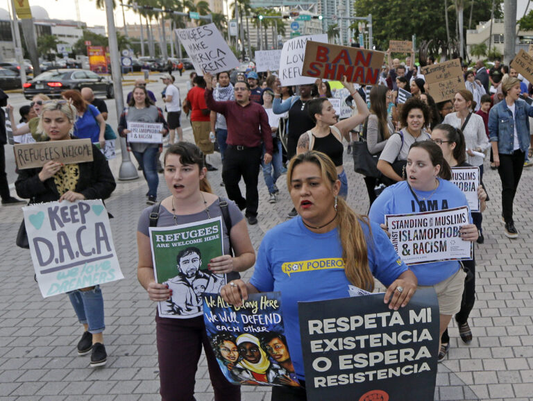Protesters chant slogans against President Donald Trump's executive order on immigration Thursday, Jan. 26, 2017, in downtown Miami. The protesters manifested their opposition to Trump's executive order restricting immigration from some Middle Eastern and African countries. (AP Photo/Alan Diaz) (AP Photo/Alan Diaz)
