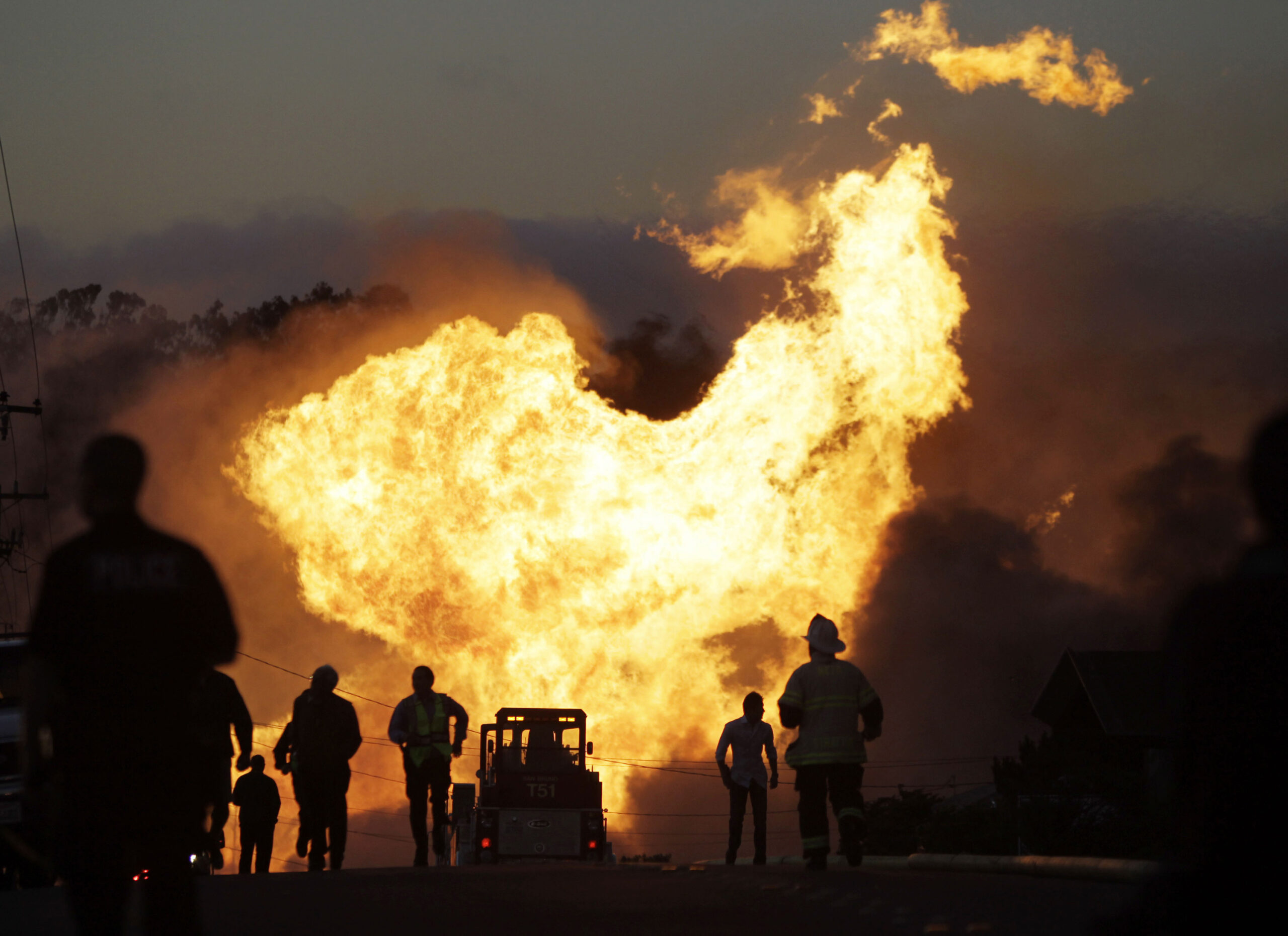 FILE - In this Sept. 9, 2010 file photo, a massive fire roars through a neighborhood in San Bruno, Calif. Pacific Gas & Electric Co. says it is prepared to pay the maximum fine of $3 million after a jury convicted the company of deliberately violating pipeline safety regulations before a deadly natural gas pipeline explosion in the San Francisco Bay Area and then misleading investigators looking into the blast. (AP Photo/Paul Sakuma, File) (AP)