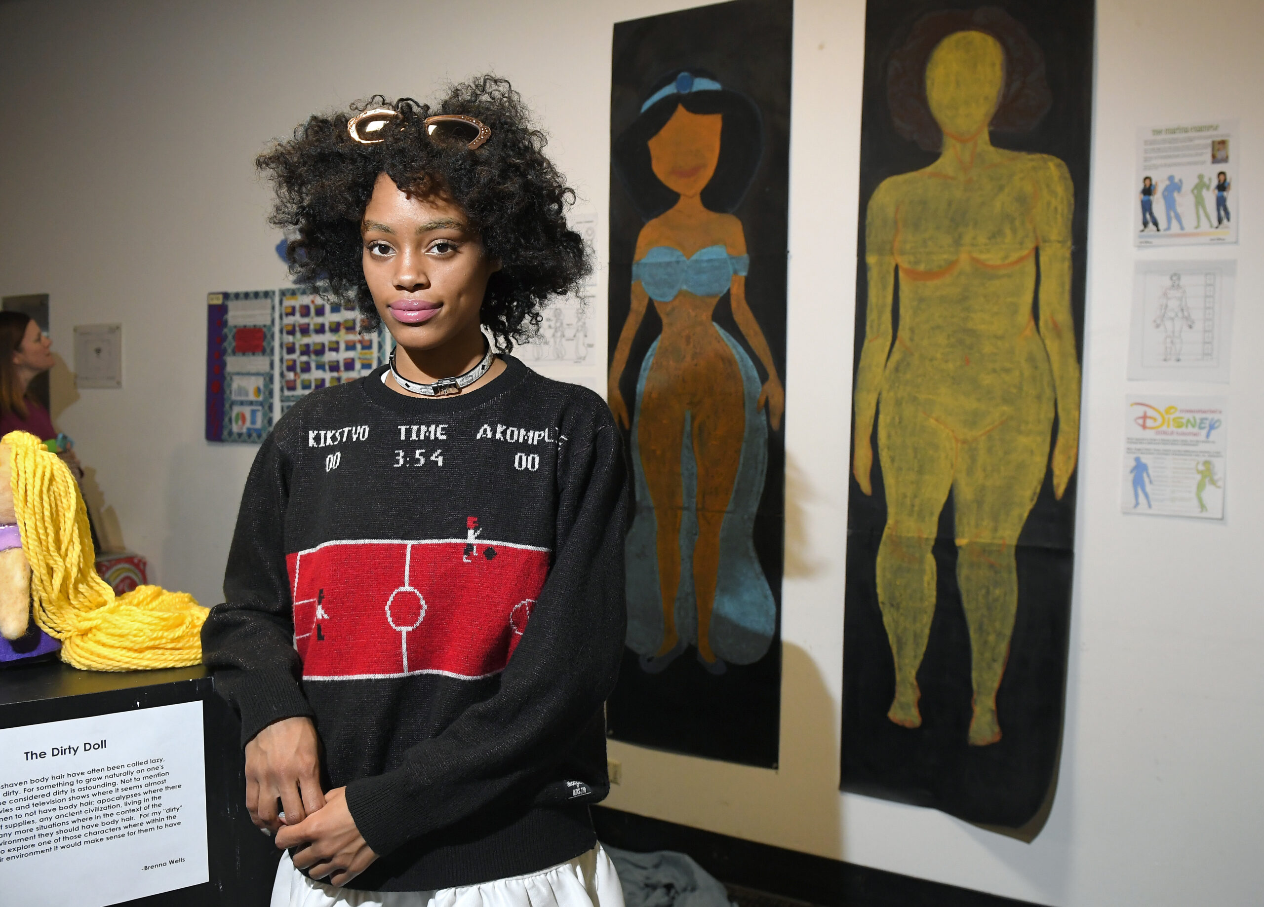 In this Friday, Dec. 9, 2016, photo, Ajani Russell poses with her artwork "Female Figures" prior to the Animated Women symposium at California Institute of the Arts, in Valencia, Calif. The California Institute of the Arts was created partly by Walt Disney's desire to bring more top-flight animators into the profession. And it has during its 47 years, though for a long time almost all were men. Now, nearly three-quarters of CalArts' more than 250 animation students are women, and there's a new goal: Ensure that when they land jobs, they get to draw female characters reflective of the real world and not just the nerds, sex bombs, tomboys or ugly villains who proliferate now. (AP Photo/Mark J. Terrill) (AP)