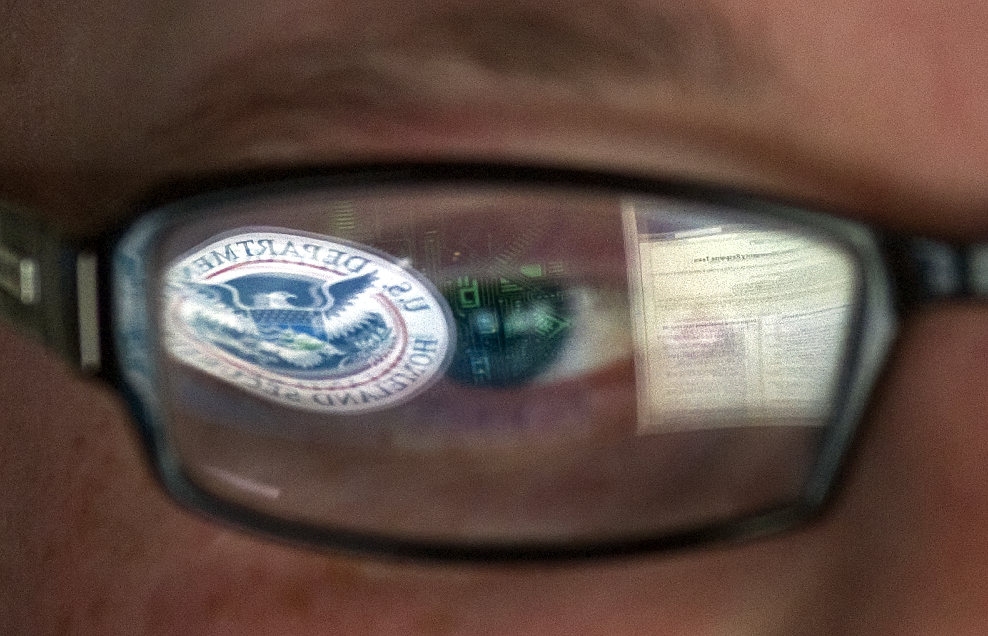 FILE - In this Sept. 30, 2011, file photo, a reflection of the Department of Homeland Security logo is seen reflected in the glasses of a cyber security analyst in the watch and warning center at the Department of Homeland Security's secretive cyber defense facility at Idaho National Laboratory in Idaho Falls, Idaho. Through history, the United States has relied on its borders and superior military might to protect against and deter foreign aggressors. But a lack of boundaries and any rulebook in cyberspace has increased the threat and leveled the playing field today. (AP Photo/Mark J. Terrill, File) (AP)
