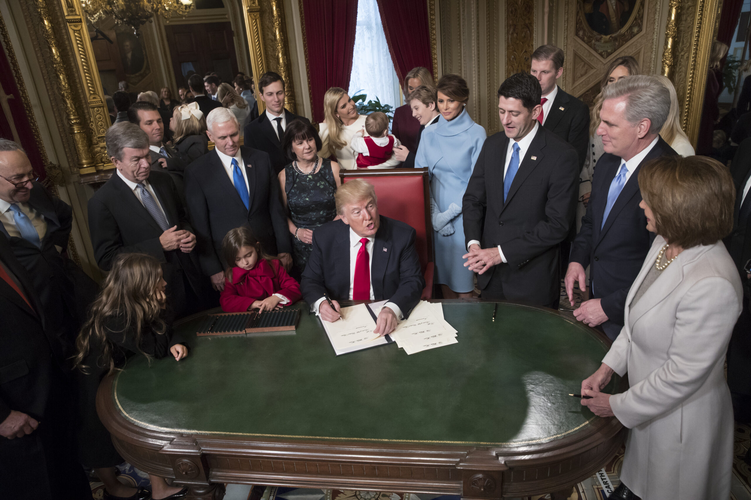 President Donald Trump is joined by the Congressional leadership and his family as he formally signs his cabinet nominations into law, in the President's Room of the Senate, at the Capitol in Washington, Friday, Jan. 20, 2017. From left are Senate Minority Leader Chuck Schumer, D-N.Y., Sen. Roy Blunt, R-Mo., Donald Trump Jr., Vice President Mike Pence, Jared Kushner, Karen Pence, Ivanka Trump, Barron Trump, Melania Trump, Speaker of the House Paul Ryan, R-Wis., Majority Leader Kevin McCarthy, D-Calif., House Minority Leader Nancy Pelosi, D-Calif. (AP Photo/J. Scott Applewhite, Pool) (AP)