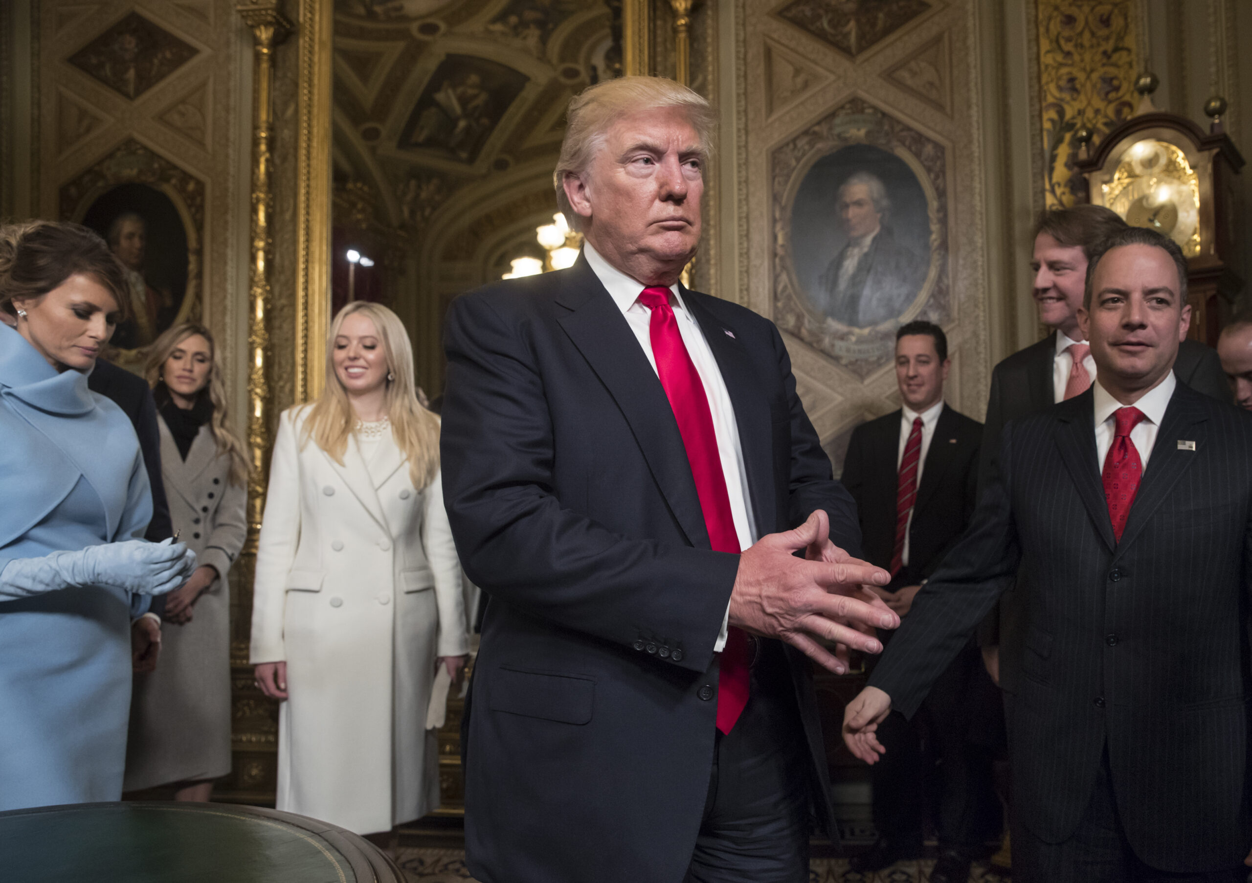 President Donald Trump leaves the President's Room of the Senate at the Capitol after he formally signed his cabinet nominations into law, in Washington, Friday, Jan. 20, 2017. He is joined by his wife Melania Trump and and daughter Tiffany Trump. At far right is Chief of Staff Reince Priebus, with White House counsel Donald McGahn, second from right. (AP Photo/J. Scott Applewhite, Pool) (AP)