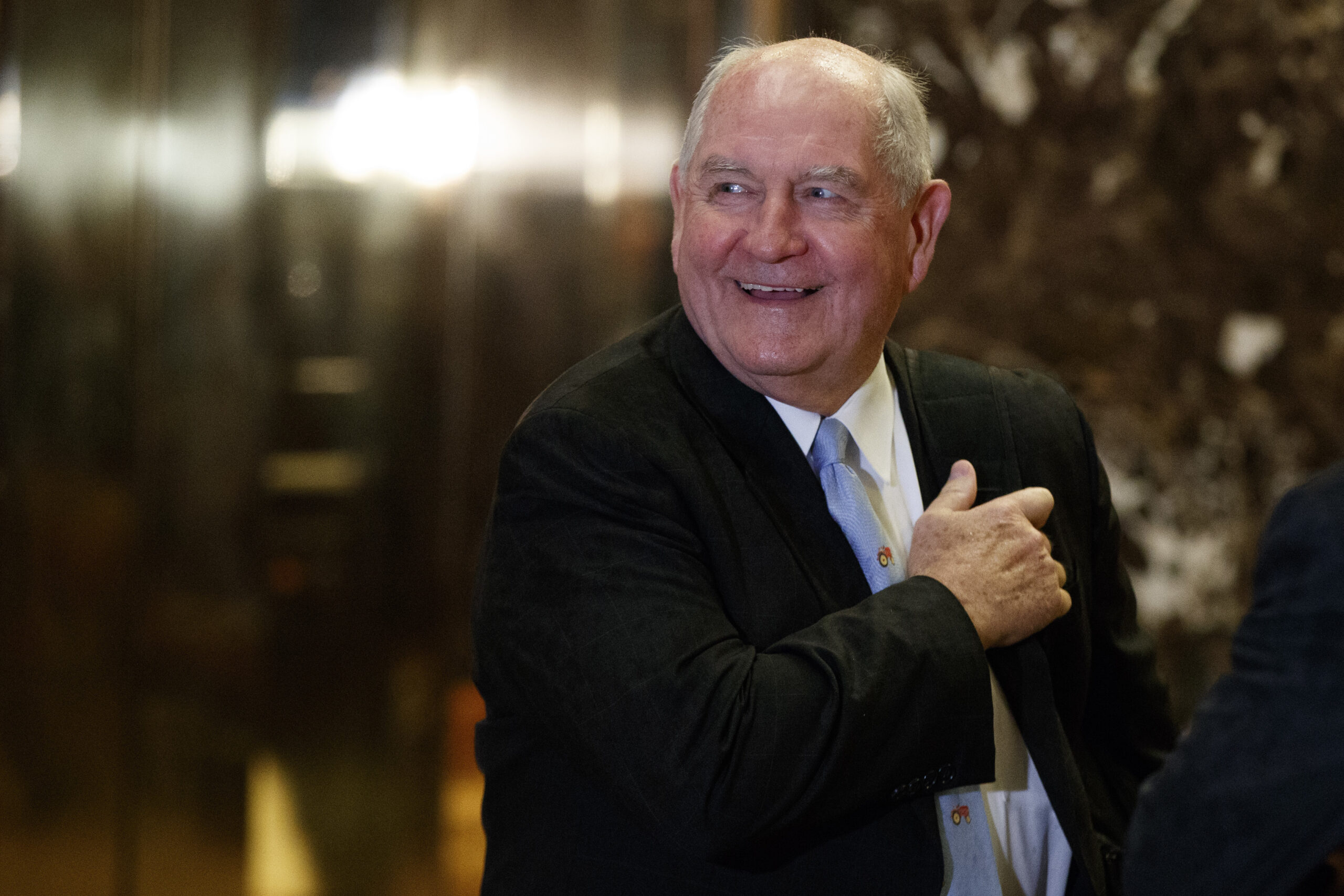 FILE- In this Nov. 30, 2016, file photo, former Georgia Gov. Sonny Perdue smiles as he waits for an elevator in the lobby of Trump Tower in New York. A person familiar with the decision says President-elect Donald Trump has chosen Perdue to serve as agriculture secretary. (AP Photo/Evan Vucci, File) (AP)