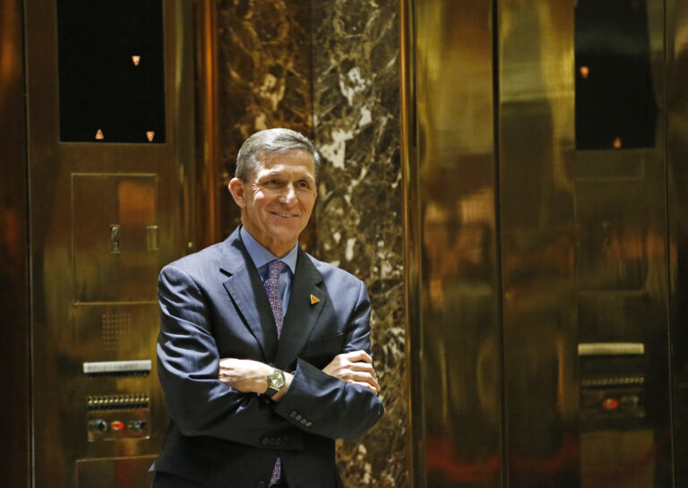 FILE - In this Dec. 12, 2016 file photo, National Security Adviser-designate Michael T. Flynn waits for an elevator in the lobby at Trump Tower in New York. The Obama administration is aware of frequent contacts between President-elect Donald Trump’s top national security adviser Michael Flynn and Russia’s ambassador to the United States, including on the day President Barack Obama hit Moscow with sanctions in retaliation for election-related hacking, a senior U.S. official said Friday, Jan. 13, 2017.  () (AP Photo/Kathy Willens, File)