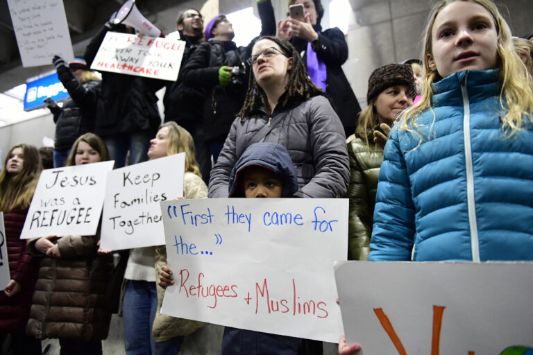 Stephanie Hartley-Bah and her son Jah'kier Hartley, 7, both of Bear, Del., listen during a protest of President Donald Trump's travel ban on refugees and citizens of seven Muslim-majority nations, Sunday, Jan. 29, 2017, at Philadelphia International Airport in Philadelphia. (AP Photo/Corey Perrine) (AP)