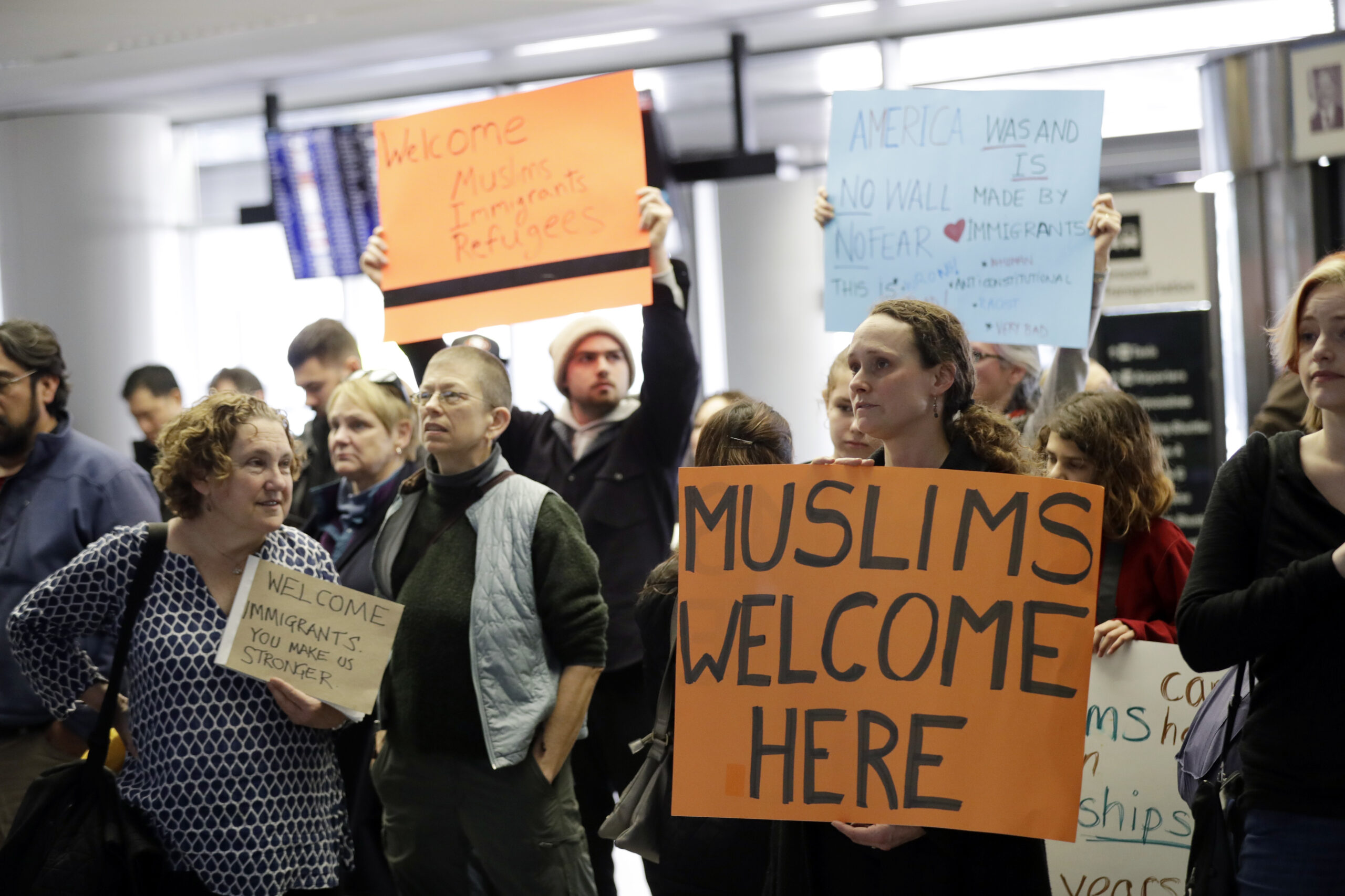 Protesters holds signs at San Francisco International Airport to denounce President Donald Trump's executive order that bars citizens of seven predominantly Muslim-majority countries from entering the U.S., Monday, Jan. 30, 2017, in San Francisco. () (AP Photo/Marcio Jose Sanchez)
