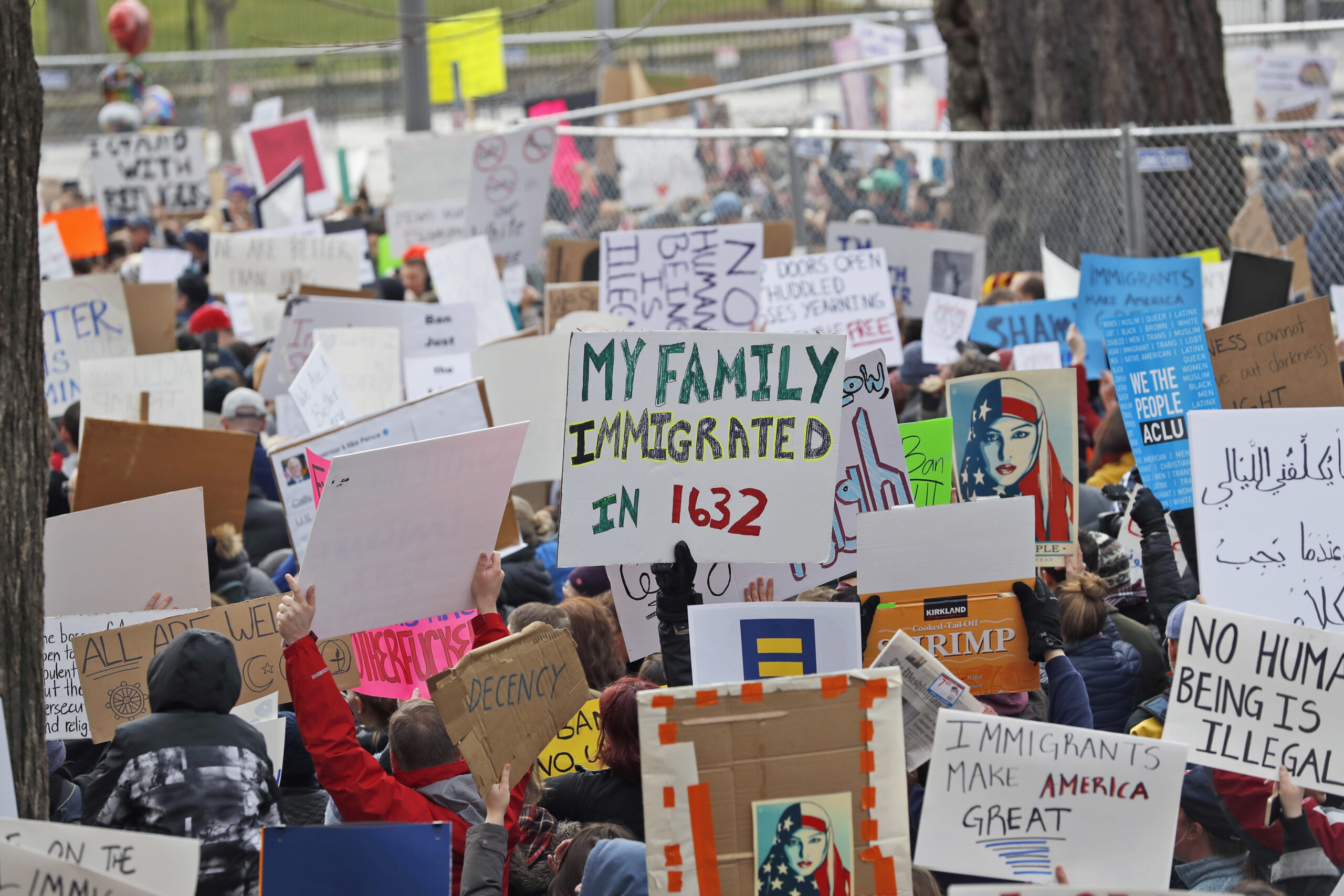 Protesters carry signs and chant in Lafayette Park near the White House during a demonstration to denounce President Donald Trump's executive order that bars citizens of seven predominantly Muslim-majority countries from entering the U.S. on Sunday, Jan. 29, 2017, in Washington. (AP Photo/Alex Brandon) (AP)