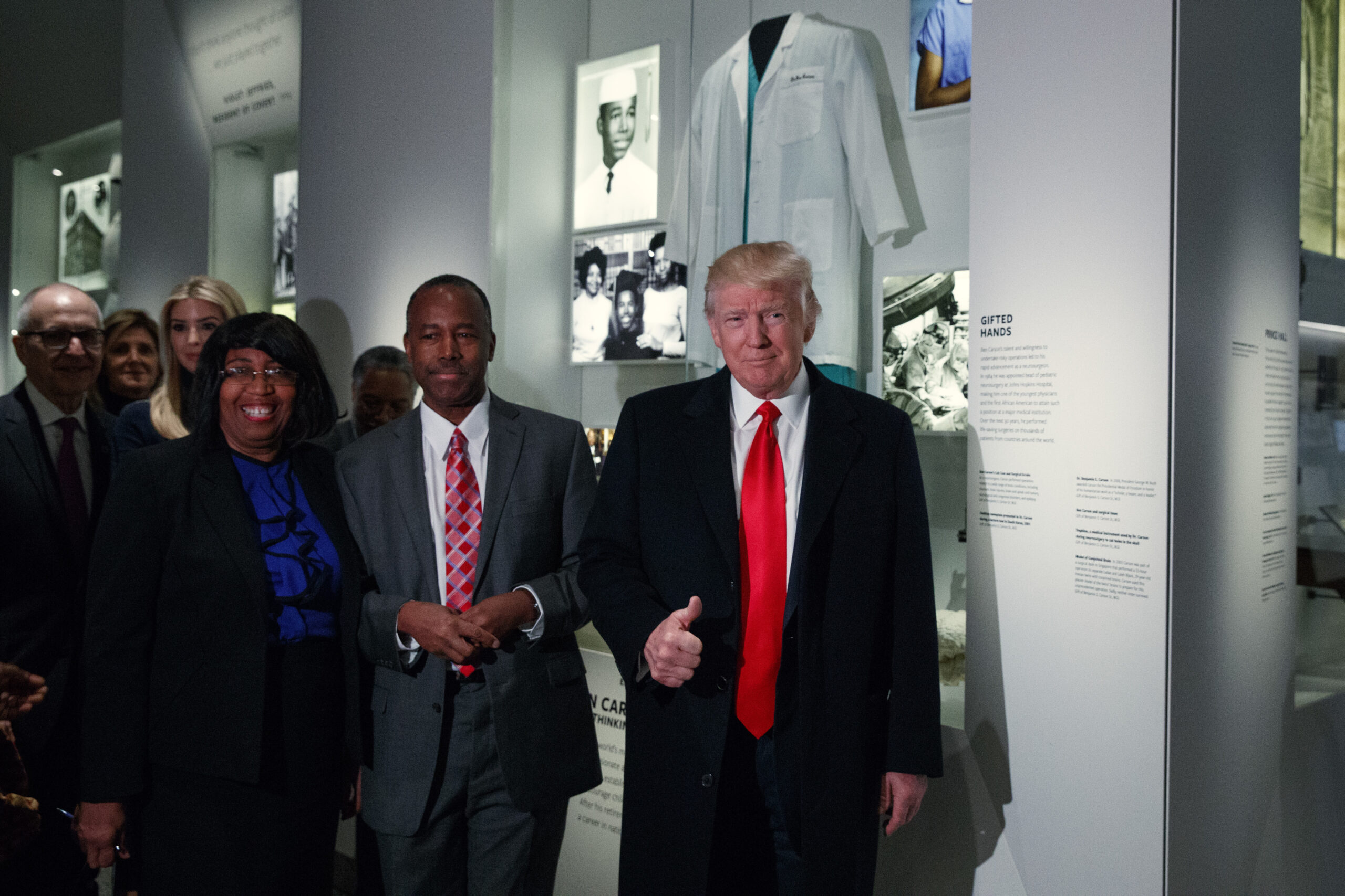 President Donald Trump gives a thumbs up during a tour of the National Museum of African American History and Culture with Housing and Urban Development Secretary-designate Dr. Ben Carson and his wife Candy Carson, Tuesday, Feb. 21, 2017, in Washington. (AP Photo/Evan Vucci) (AP)