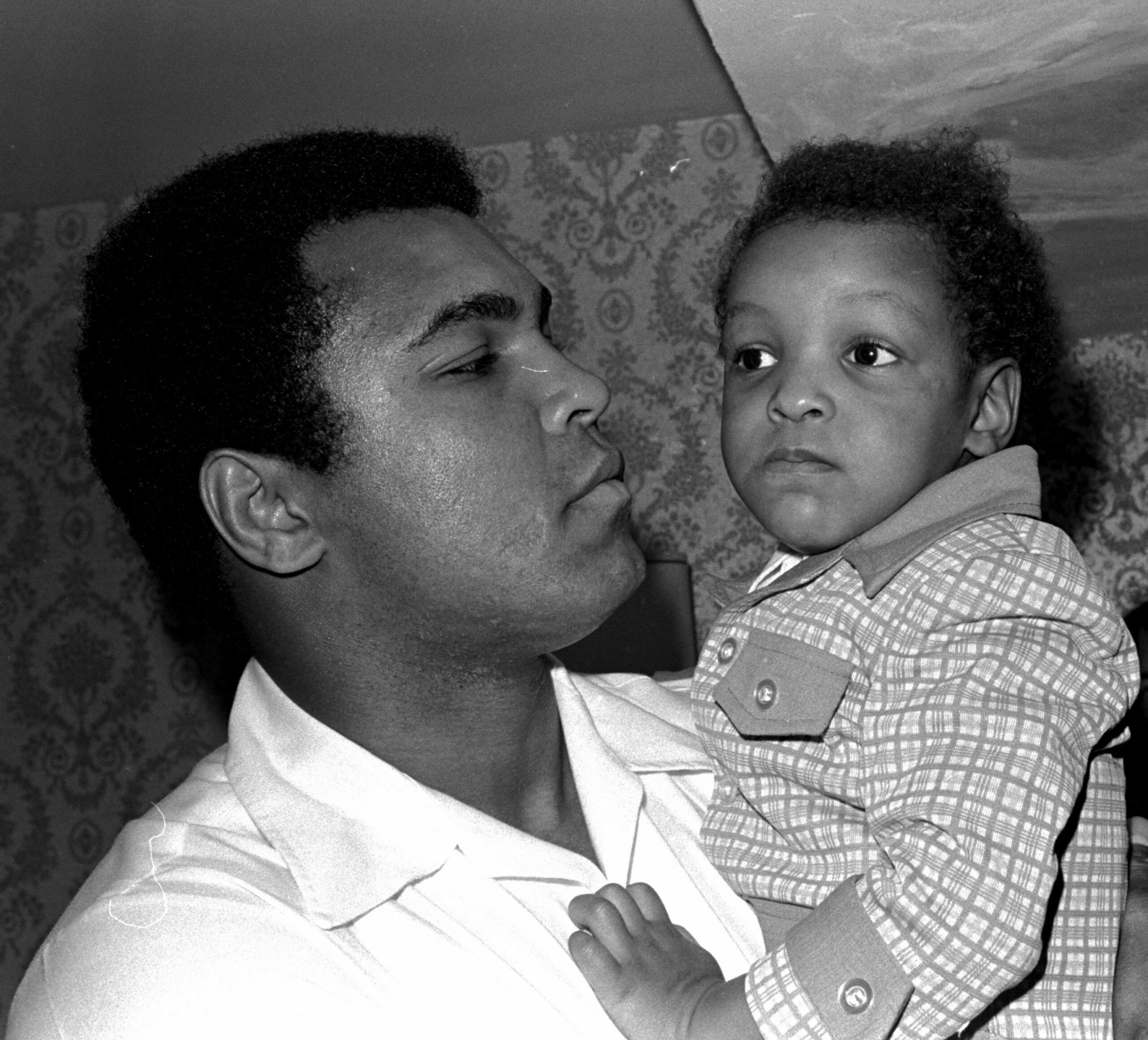 Heavyweight boxing champion Muhammad Ali, and Little Muhammad Ali, his 2 1/2 year old son, arrive at Miami Beach, Fla. (Associated Press)