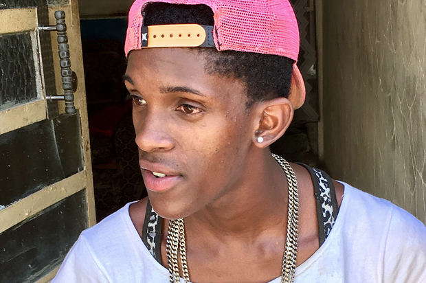 Jerzon, a young professional dancer, has a conversation with tourists in the Callejon de Hammel, Havana, Cuba (Alli Joseph/Salon)