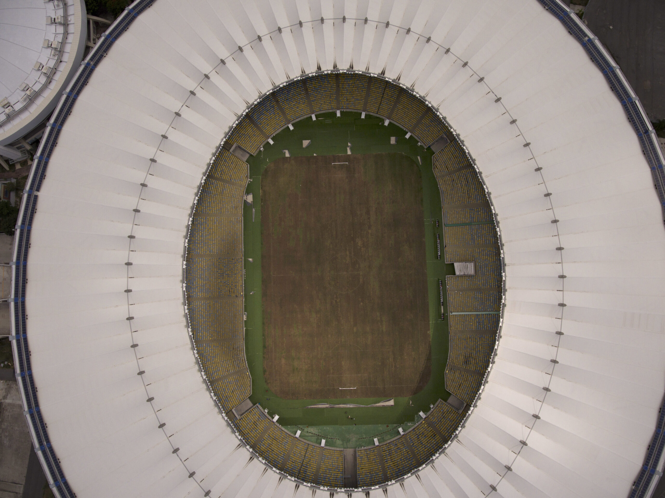 This Feb. 2, 2017 photo shows Maracana stadium's dry playing field in Rio de Janeiro, Brazil. The stadium was renovated for the 2014 World Cup at a cost of about $500 million, and largely abandoned after the Olympics and Paralympics, then hit by vandals who ripped out thousands of seats and stole televisions. (AP Photo/Mario Lobao) (AP)
