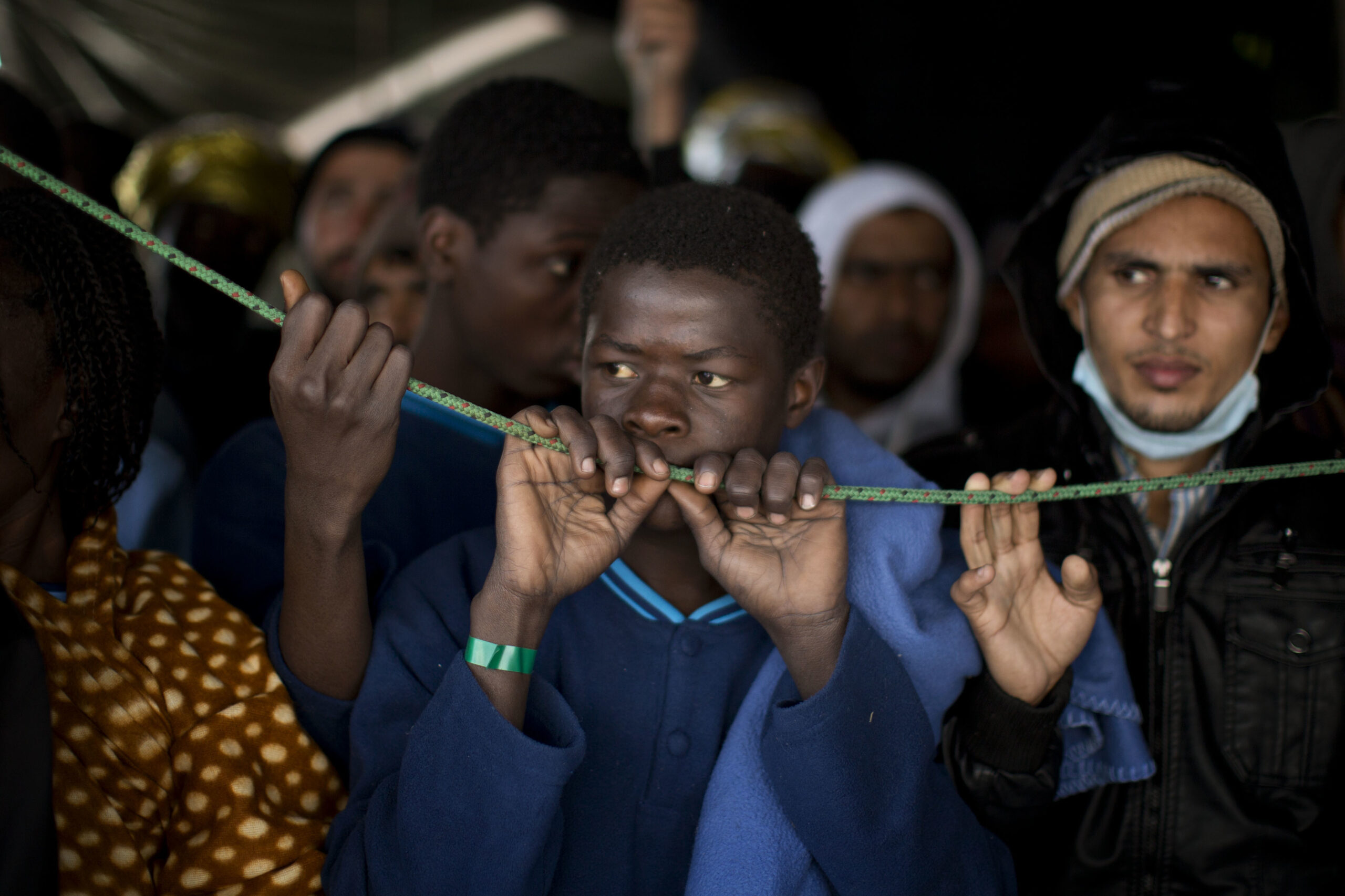 Sub-Saharan migrants wait their turn to leave the Golfo Azzurro rescue vessel after arriving at the port of Pozzallo, south of Sicily, Italy, with more than 220 migrants aboard, rescued by members of Proactive Open Arms NGO, on Sunday, Feb. 5, 2017. Rescuers from different aid organizations pulled more than 1000 people in waters off the Libyan coast on Friday, and all of them were transferred to the Italian authorities. (AP Photo/Emilio Morenatti) (AP)
