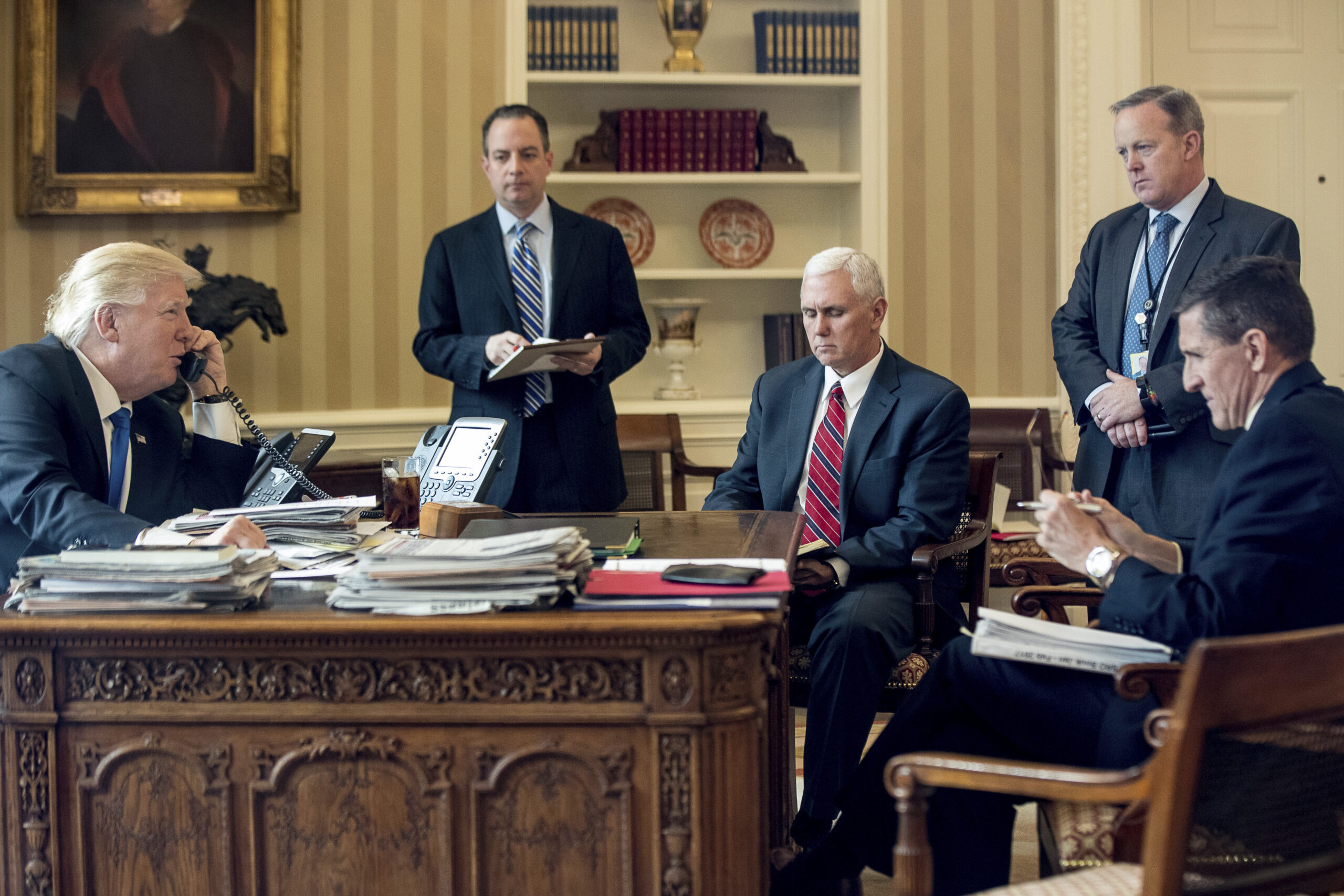 FILE - In this Jan. 28, 2017, file photo, President Donald Trump accompanied by, from second from left, Chief of Staff Reince Priebus, Vice President Mike Pence, White House press secretary Sean Spicer and National Security Adviser Michael Flynn speaks on the phone with Russian President Vladimir Putin in the Oval Office at the White House in Washington. (AP Photo/Andrew Harnik, File)