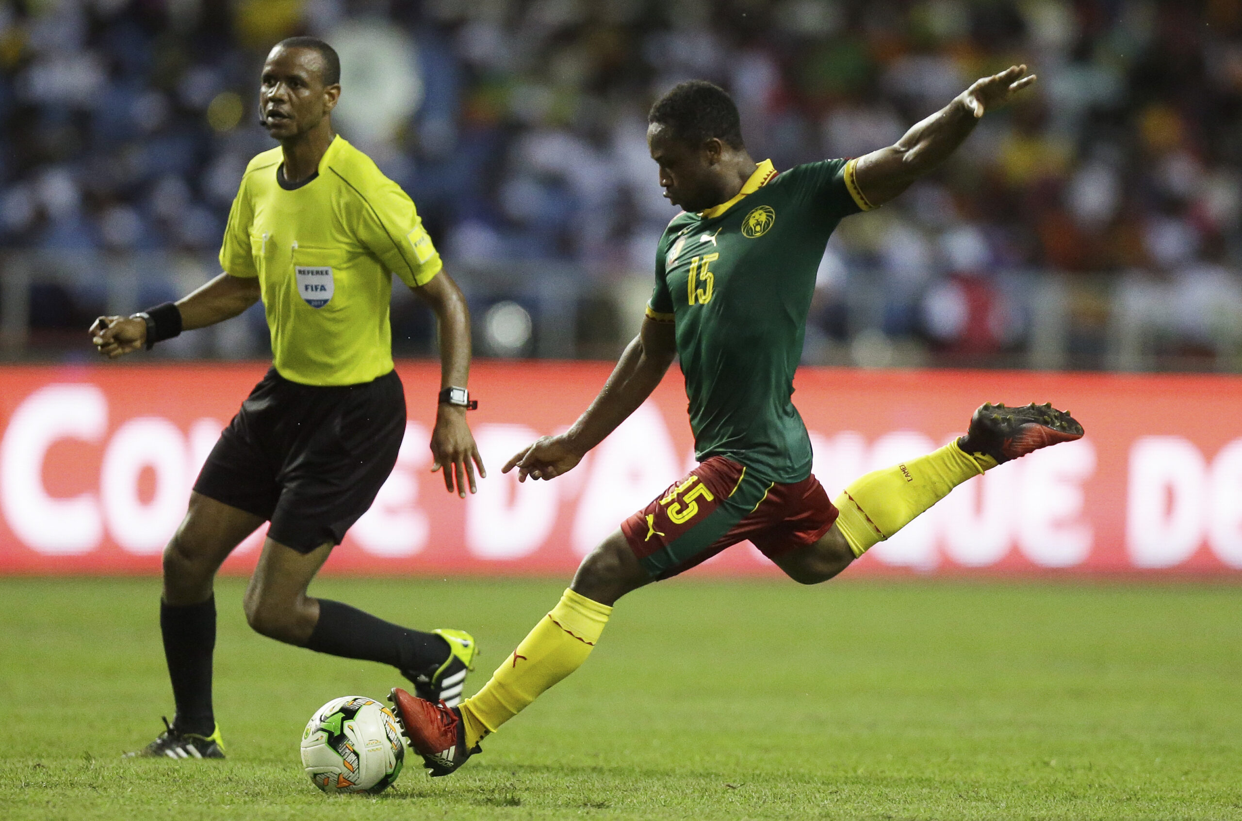 Cameroon's Sebastien Siani shoots the ball next to referee Janny Sikazwe during the African Cup of Nations final soccer match between Egypt and Cameroon at the Stade de l'Amitie, in Libreville, Gabon, Sunday, Feb. 5, 2017. (AP Photo/Sunday Alamba) (AP Photo/Sunday Alamba)