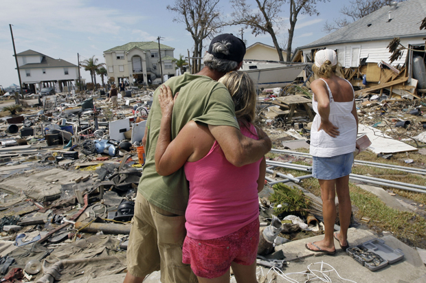 Residents look over debris left in the the aftermath of Hurricane Ike in Galveston, Texas, Sept. 24, 2008. (AP/David J. Phillip)
