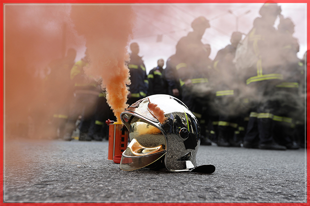 A firefighter's helmet stands next to a flare during a protest in central Athens, on Wednesday, Feb. 8 2017. Hundreds of firefighters in uniform have taken to the streets of the Greek capital to protest hiring conditions. (AP Photo/Thanassis Stavrakis) (Thanassis Stavrakis)