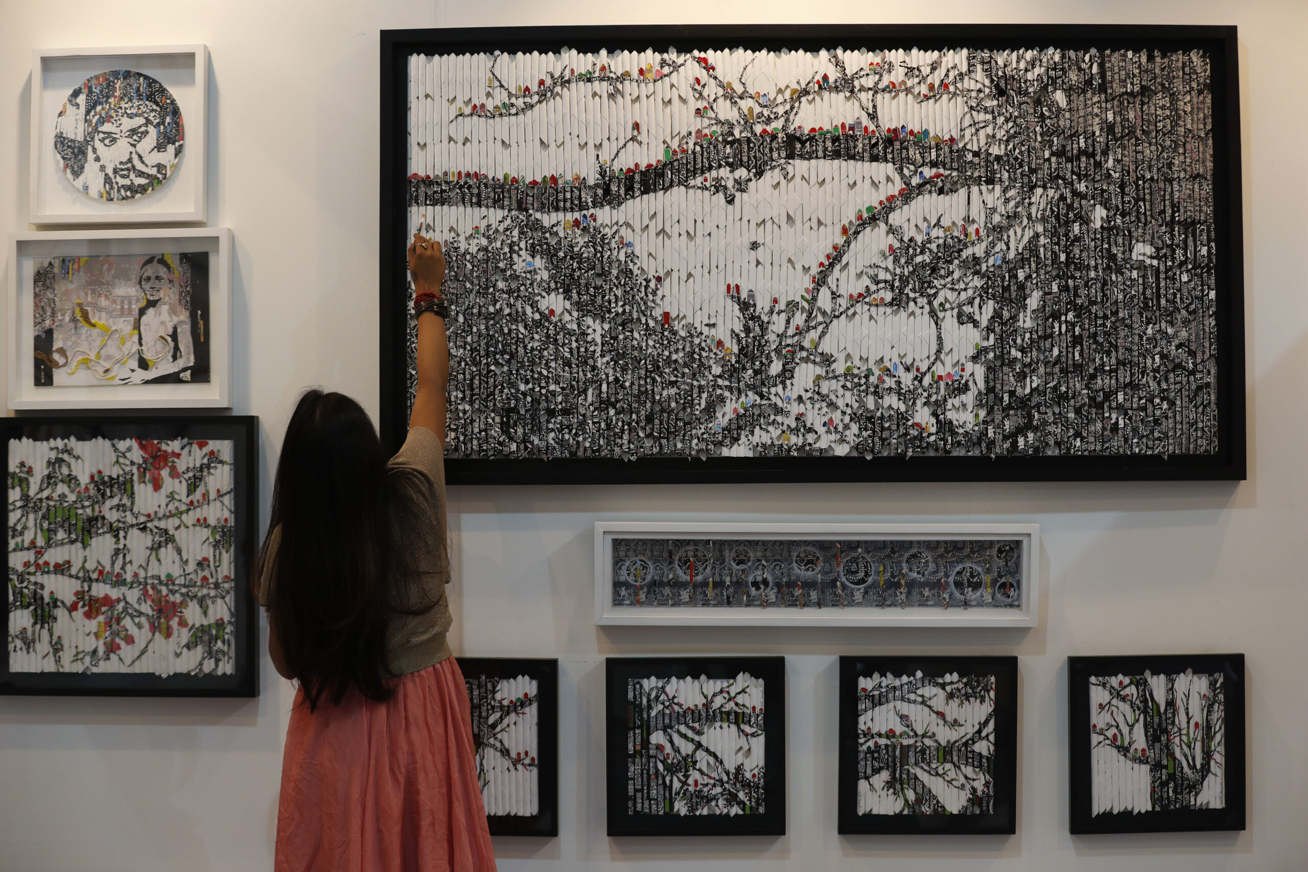Vinila Dasgupta retouches her art during India Art Fair in New Delhi, India, Thursday, Feb. 2, 2017. The four day art fair brings together a number of modern and contemporary artists to present their works. ( (AP Photo/Tsering Topgyal))