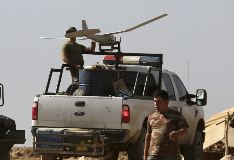 In this Friday, Oct. 21, 2016 photo, a U.S. soldier, left, prepares to launch a drone in a joint base with Iraqi army on the outskirts of Mosul, Iraq. Reverberations from President Donald Trump’s travel ban and other stances are threatening to undermine future U.S.-Iraqi security cooperation, rattling a key alliance that over the past two years has slowly beaten back the Islamic State group. Iraq’s prime minister, Haider al-Abadi, has sought to contain public anger sparked by the ban and by Trump’s repeated statements that the Americans should have taken Iraq’s oil, as well as his hard line against Iran, a close ally of Baghdad. (AP Photo/Khalid Mohammed) (AP)