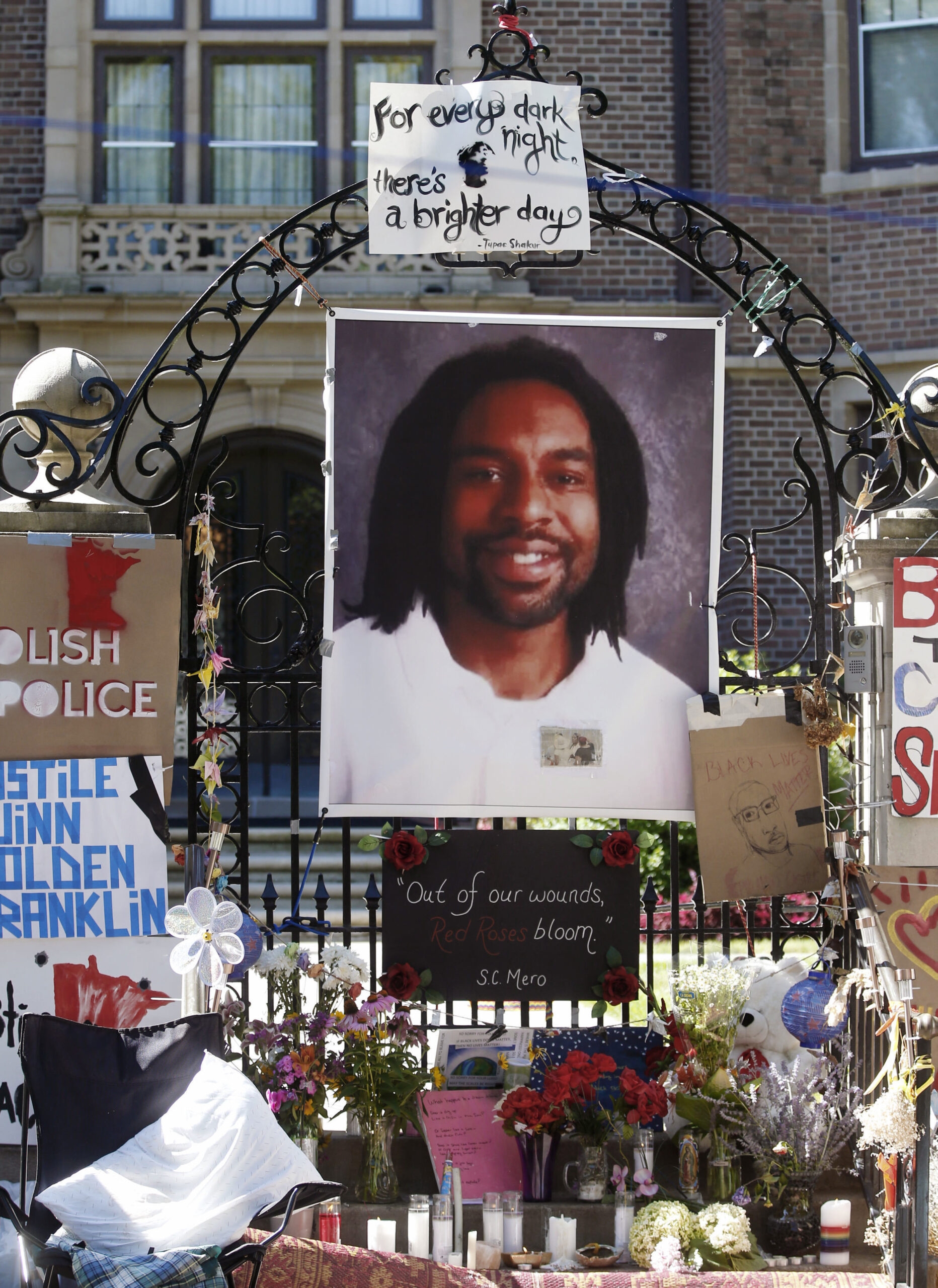 FILE - In this July 25, 2016, file photo, a memorial including a photo of Philando Castile is attached to the gate to the governor's residence where protesters demonstrated in St. Paul, Minn. Attorneys for Jeronimo Yanez, the Minnesota police officer accused of fatally shooting Castile say Castile's gun was accessible and that he was reaching for it when he was killed. A memo filed Tuesday, Feb. 7, 2017, in Ramsey County District Court contradicts prosecutors' claims that St. Anthony Officer Yanez didn't see the weapon and made conflicting statements about it. (AP Photo/Jim Mone, File) (AP)