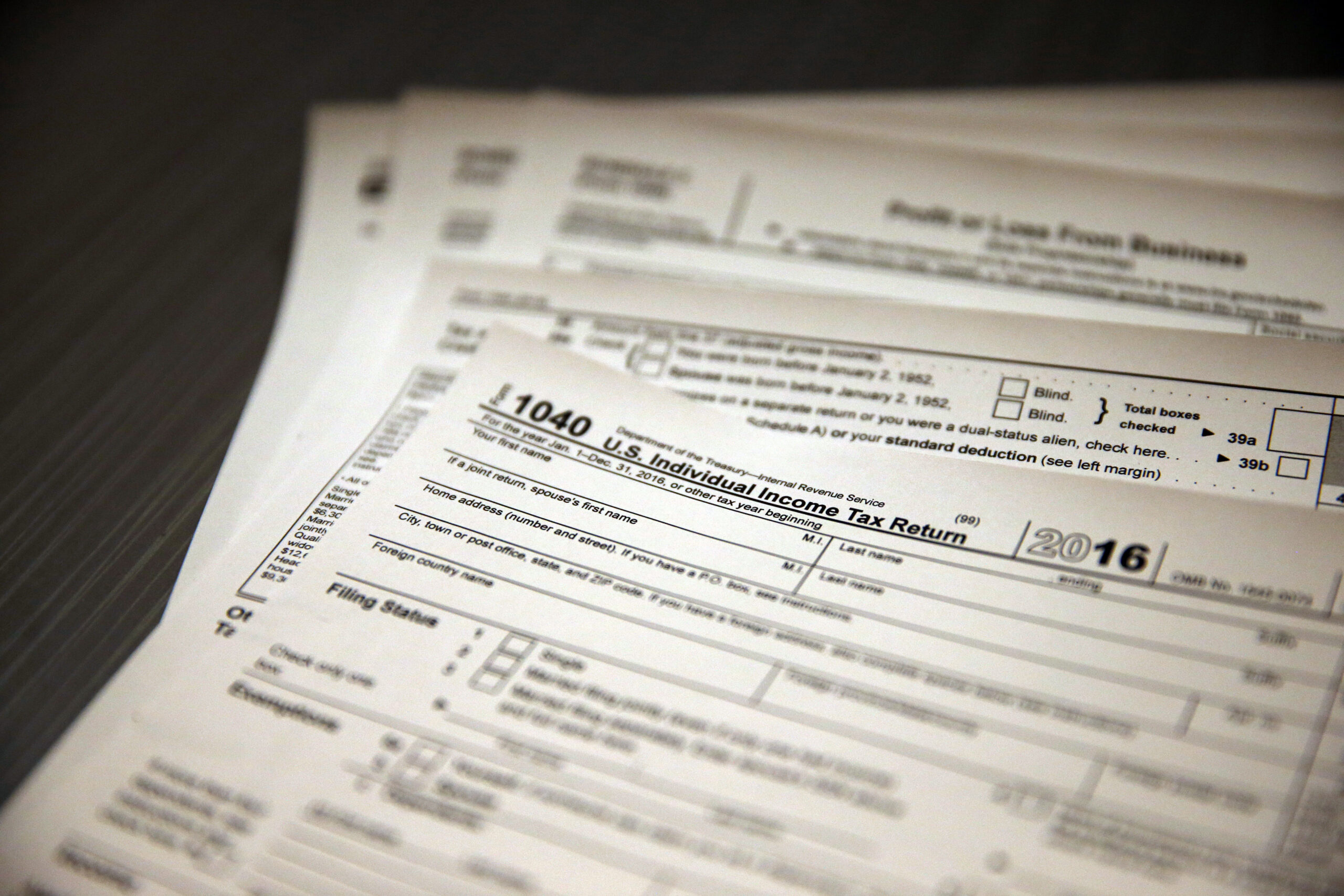 In this Jan. 14, 2017, photo, tax forms sit on a desk at the start of the tax season rush, inside the offices of tax preparation firm Infinite Tax Solutions, in Boulder, Colo. Filing taxes early could speed your return and protect your identity. (AP Photo/Brennan Linsley) (AP)