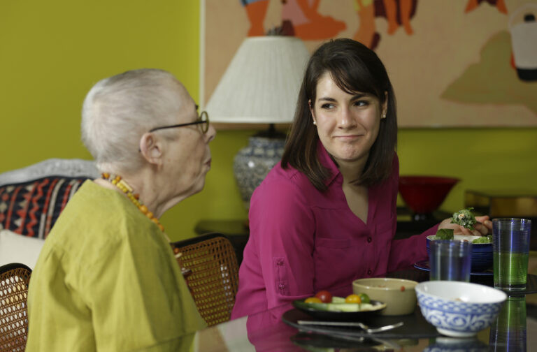 In this Friday, Feb. 17, 2017 photo, Laura Berick, left, a retired art dealer, has lunch with Justine Myers at Berick's home at Judson Manor, in Cleveland. In a research project, graduate-level students live among residents of the Judson Manor retirement home. The study looks at the impact of isolation and loneliness, aging and stereotypes of retirees by students and vice versa. Myers is an artist-in-residence at Judson Park. She is an Oberlin College graduate student studying music. (AP Photo/Tony Dejak) (AP)