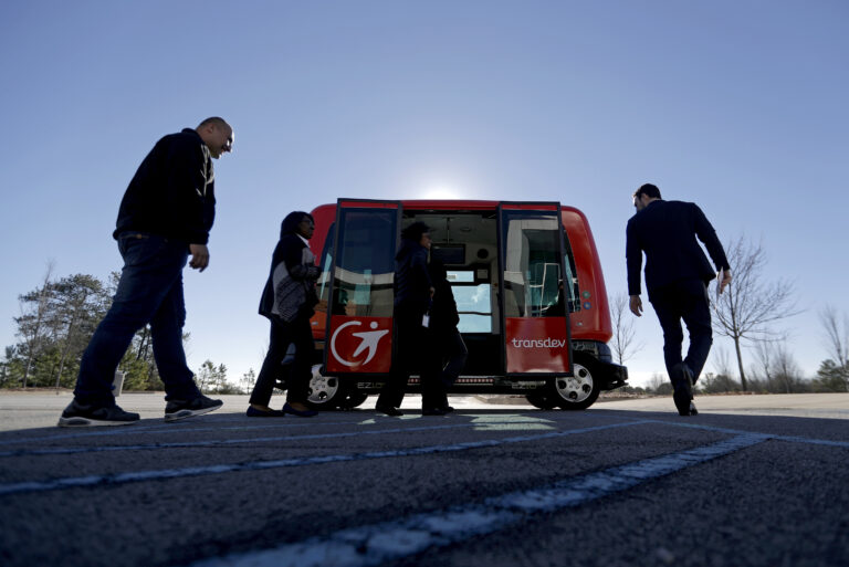 In this Thursday, Jan. 26, 2017 photo, a driverless shuttle sits on display at the Riverside EpiCenter in Austell, Ga. Self-driving vehicles could begin tooling down a bustling Atlanta street full of cars, buses, bicyclists and college students, as the city vies with other communities nationwide to test the emerging technology. (AP Photo/David Goldman) (AP Photo/David Goldman)