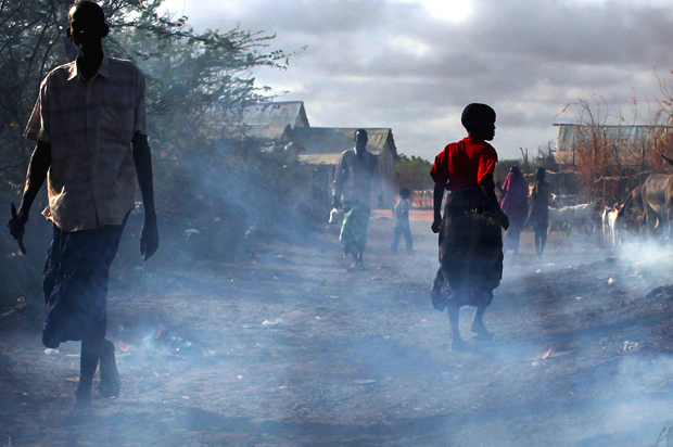 People walk through burning refuse in Dadaab, Kenya the world's biggest refugee complex August 20, 2009 in Dadaab, Kenya (Getty/Spencer Platt)