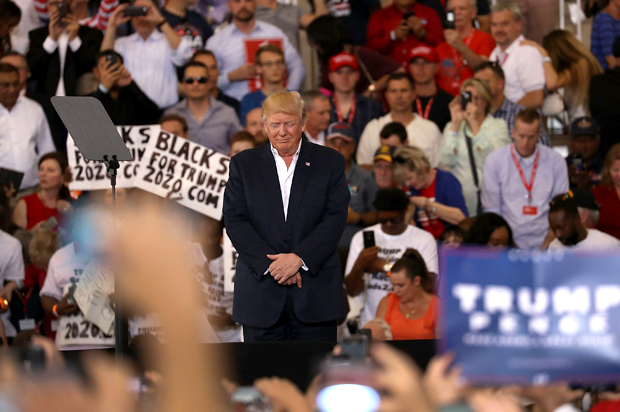 Donald Trump bows his head in prayer as his wife recites a prayer during a campaign rally on February 18, 2017 in Melbourne, Florida (Getty/Joe Raedle)
