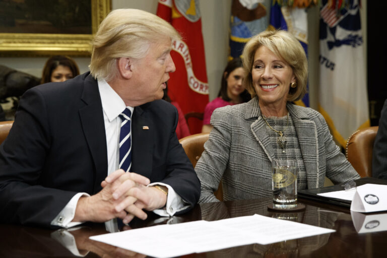 President Donald Trump looks at Education Secretary Betsy DeVos as he speaks during a meeting with parents and teachers, Tuesday, Feb. 14, 2017, in the Roosevelt Room of the White House in Washington. (AP Photo/Evan Vucci) (AP)