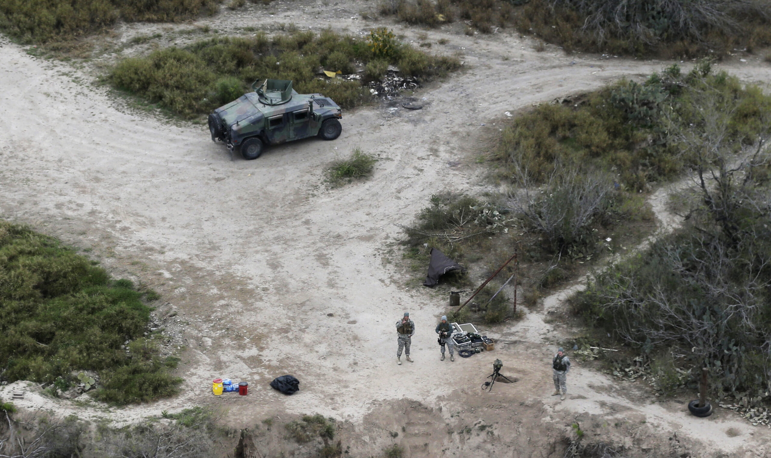 FILE - In this Feb. 24, 2015, file photo, members of the National Guard patrol along the Rio Grande at the Texas-Mexico border in Rio Grande City, Texas. The Trump administration is considering a proposal to mobilize as many as 100,000 National Guard troops to round up unauthorized immigrants, including millions living nowhere near the Mexico border, according to a draft memo obtained by The Associated Press. (AP Photo/Eric Gay, File) (AP)