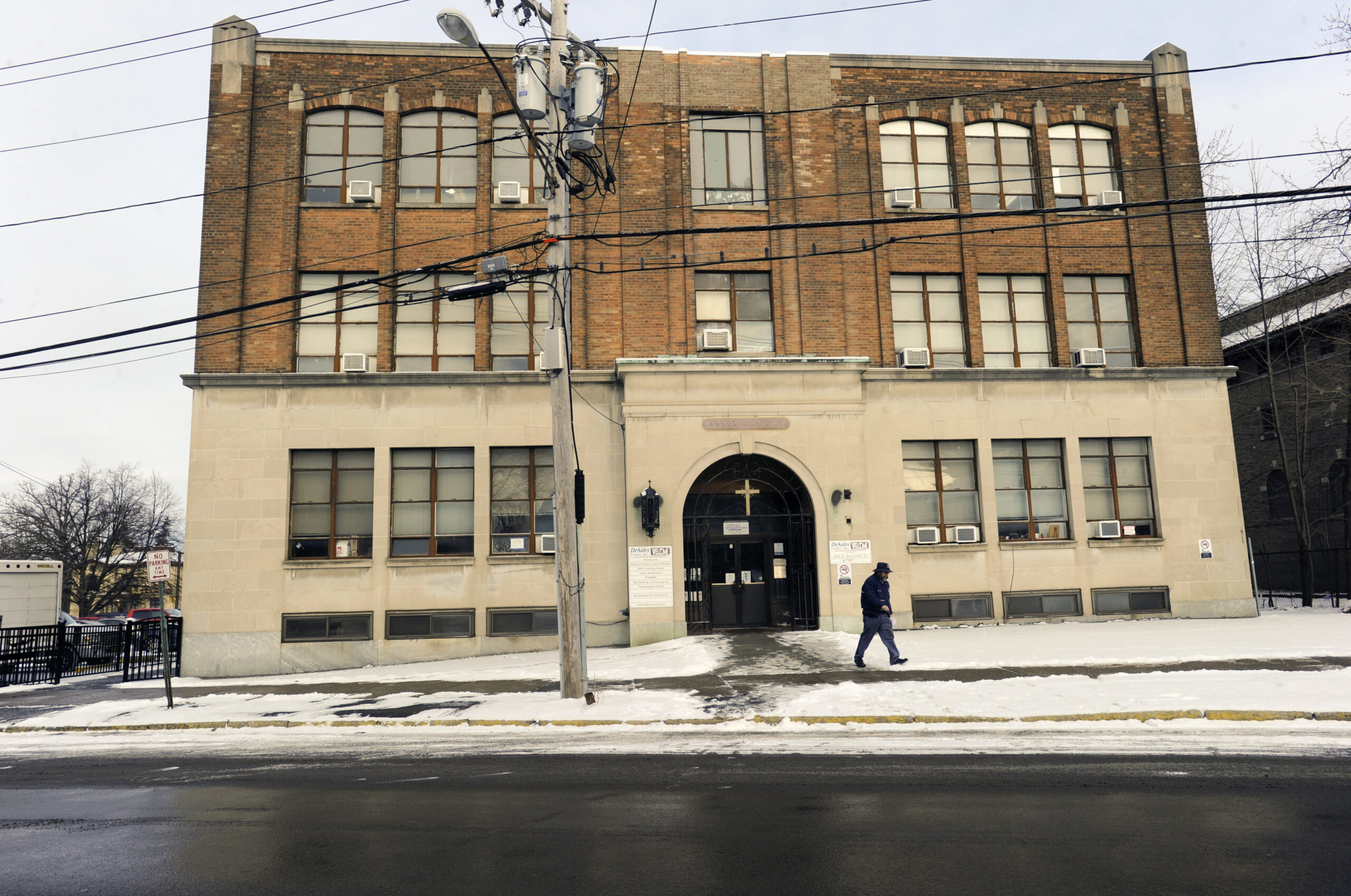 In this Jan. 31, 2017 photo, a pedestrian passes the Mohawk Valley Resource Center for Refugees building in Utica, N.Y. Utica has been a refugee "oasis" for decades. Vietnamese, Bosnians, Somalians and Burmese have each found shelter in the city that has benefited from the infusion of house-proud residents who work in hospitals, factories and their own businesses. But now President Donald Trump's executive order crimping the flow of refugees has sent a shudder through the city in upstate New York. (AP Photo/Hans Pennink) (AP)