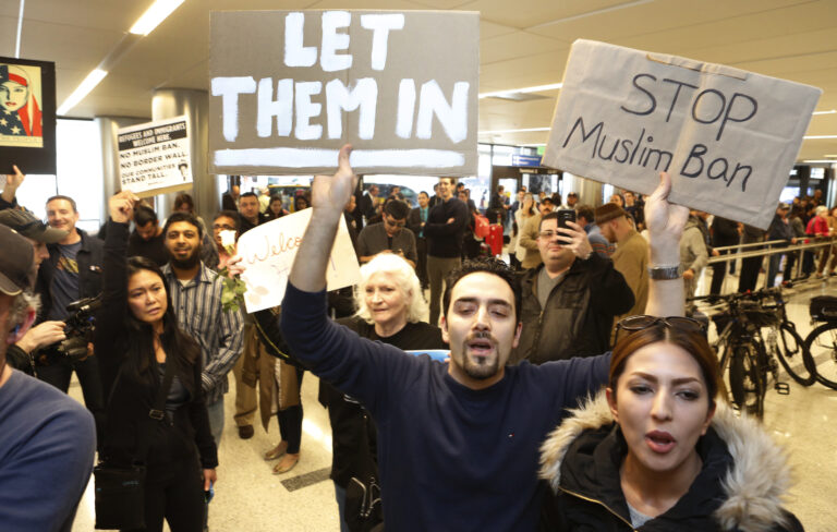 Supporters cheer as an Iranian citizen with a valid U.S. visa arrives at Los Angeles International Airport. (AP)