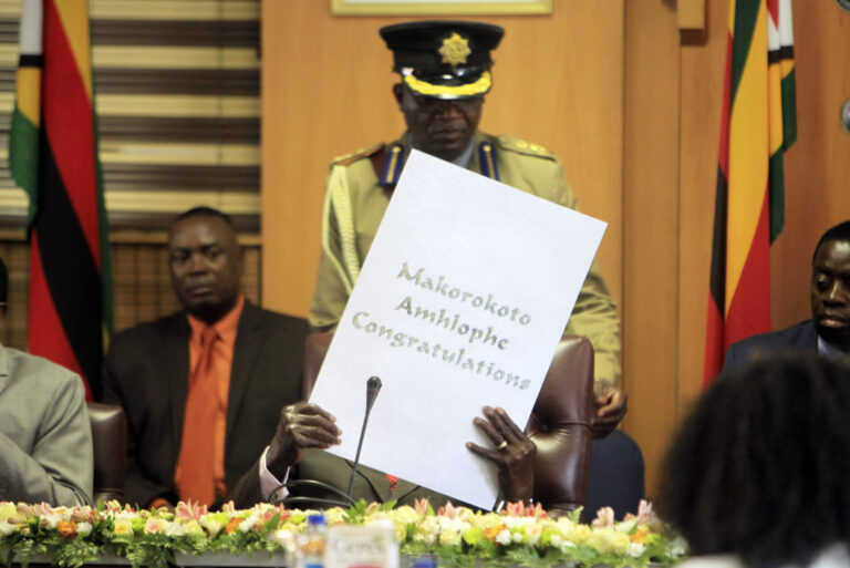 Zimbabwe's President Robert Mugabe reads his birthday card as he marks his 93rd birthday at his offices in Harare, Tuesday, Feb. 21, 2017. Mugabe described his wife Grace, an increasingly political figure, as "fireworks" in an interview marking his 93rd birthday. (AP Photo/Tsvangirayi Mukwazhi) (AP)