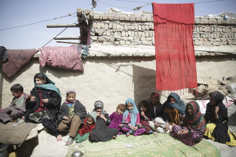In this Sunday, March 19, 2017 photo, Children sit in the sun in their home in Kabul, Afghanistan. An aid group says nearly a third of all children in war-torn Afghanistan are unable to attend school, leaving them at increased risk of child labor, recruitment by armed groups, early marriage and other forms of exploitation. (AP Photos/Massoud Hossaini) (AP)