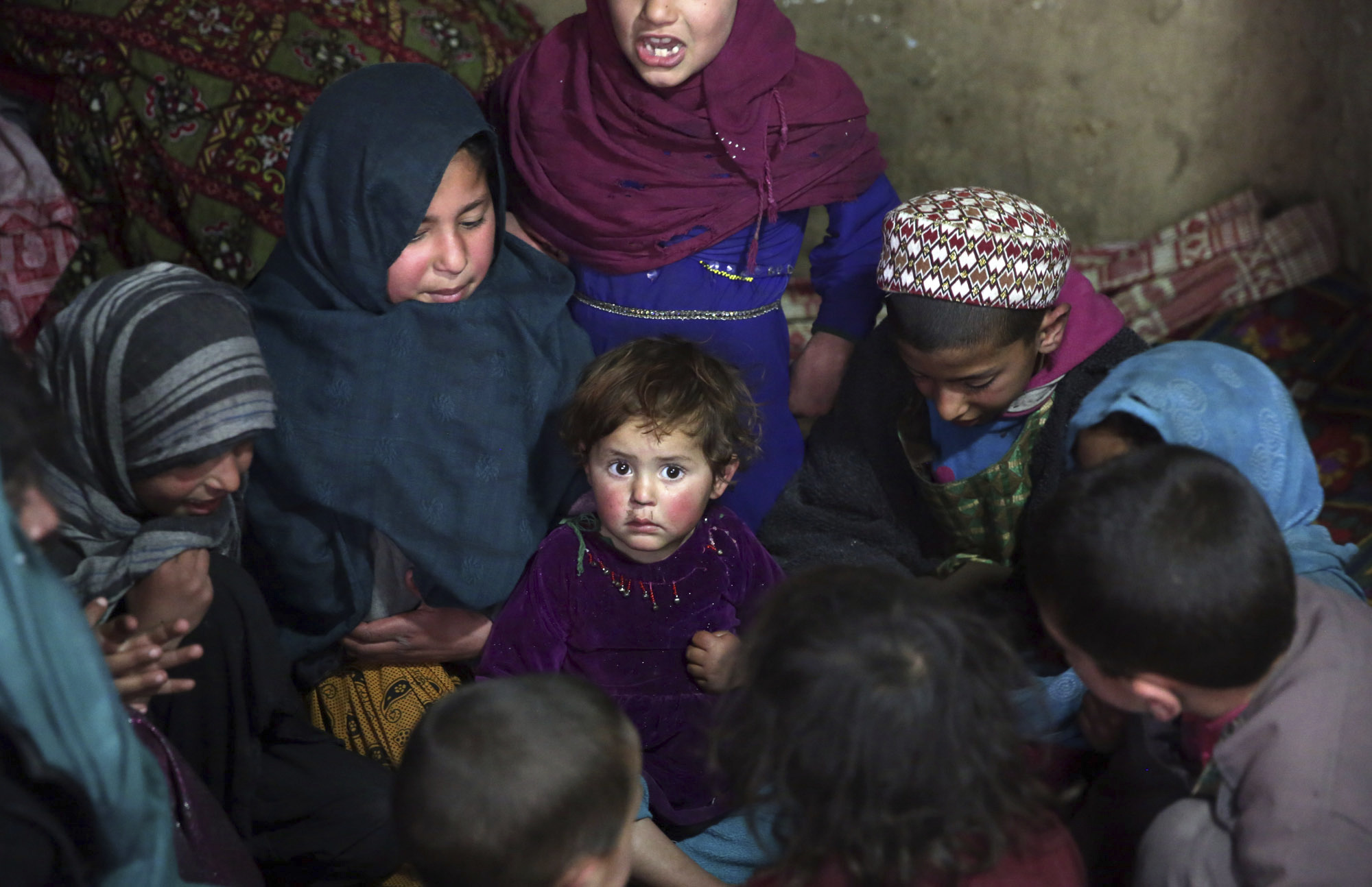 In this Sunday, March 19, 2017 photo, children play in their home in Kabul, Afghanistan. An aid group said Wednesday, March 22, 2017 that nearly a third of all children in war-torn Afghanistan are unable to attend school, leaving them at increased risk of child labor, recruitment by armed groups, early marriage and other forms of exploitation. (AP Photos/Massoud Hossaini) (AP)