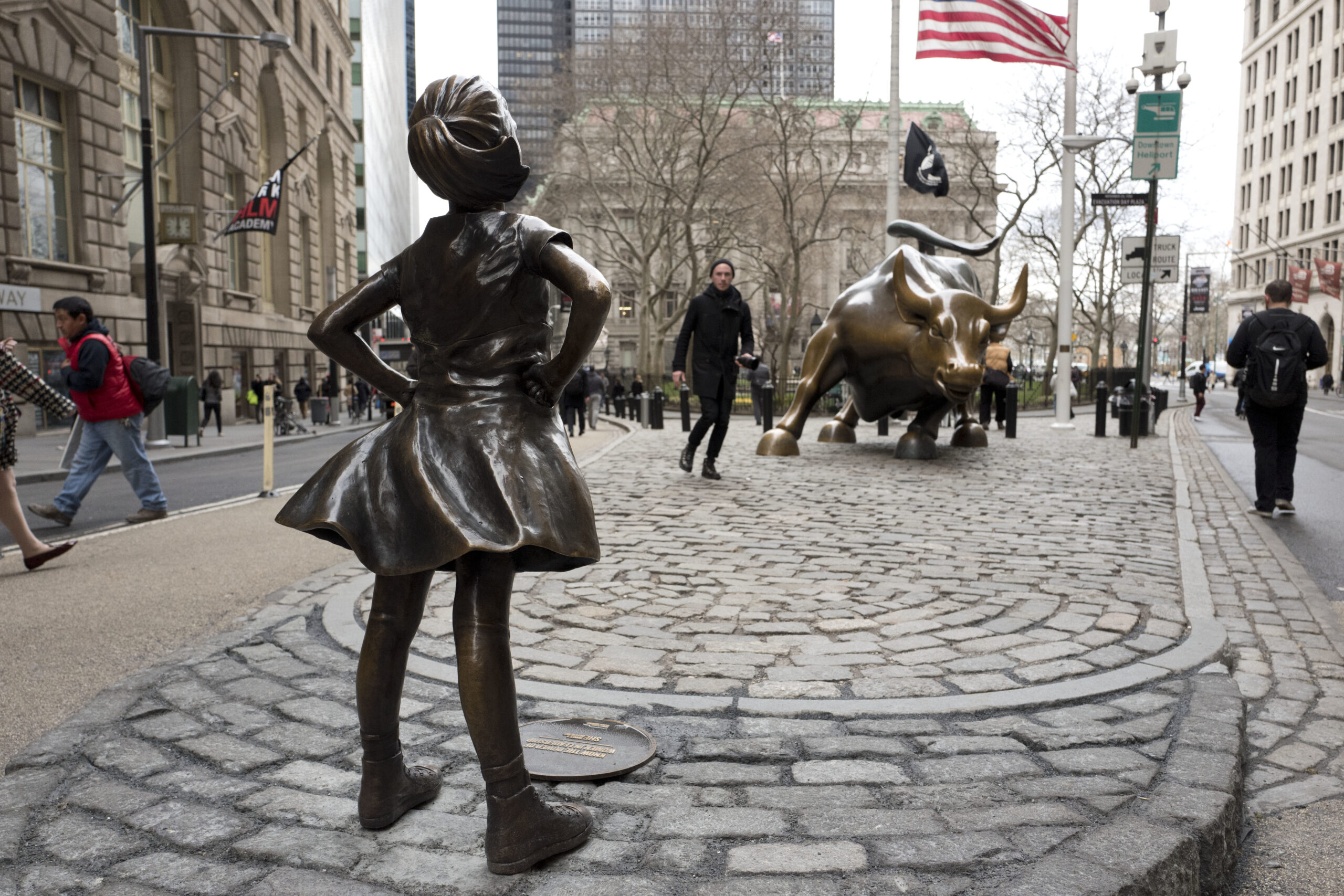 A statue titled "Fearless Girl" faces the Wall Street bull, Wednesday, March 8, 2017, in New York.   A big investment firm, State Street Global Advisors, put the statue there to highlight International Women's Day.  The work by artist Kristen Visbal.  (AP Photo/Mark Lennihan) (AP)