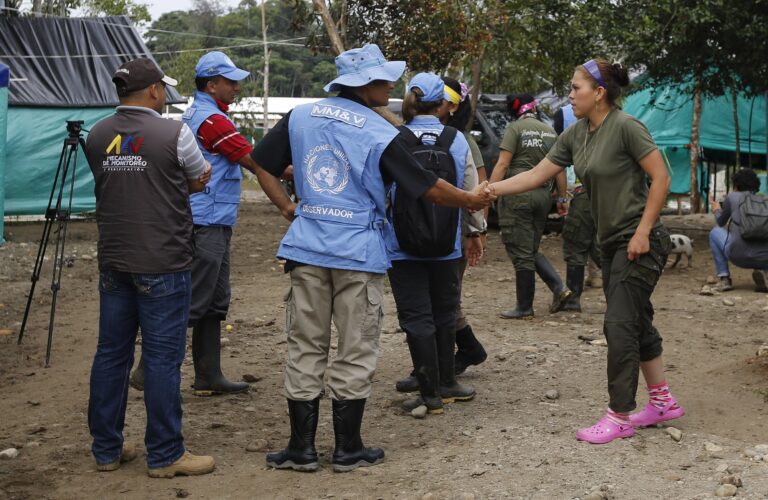 A United Nation observer shakes hands with a rebel of Revolutionary Armed Forces of Colombia, FARC, before a meeting in La Carmelita near Puerto Asis in Colombia's southwestern state of Putumayo,Wednesday, March 1, 2017. Thousands of leftist rebels are taking an important step in Colombia’s peace process by providing to UN observers an inventory of the weaponry they will soon surrender. (AP Photo/Fernando Vergara) (AP)