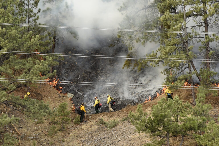 Crews battle the Sunshine Fire in the Sunshine canyon area of Boulder, Colo. on Sunday, March 19, 2017. The small wildfire forced people from their homes early Sunday and ignited dead trees that exploded into black plumes of smoke, authorities and residents said. (Jeremy Papasso/Daily Camera via AP) (AP)