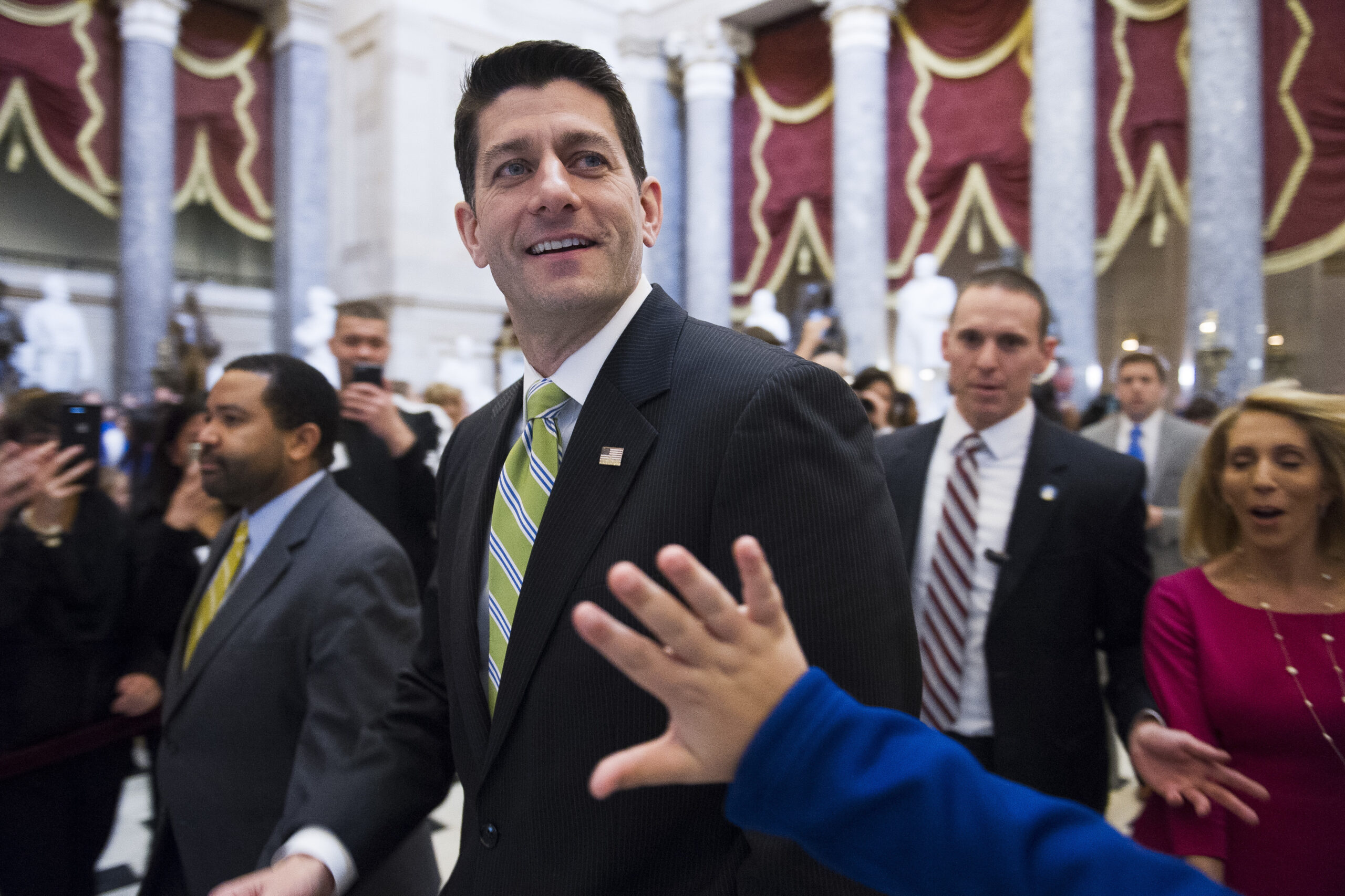 House Speaker Paul Ryan of Wisc., passes a waving tourist as he walks from the House Chamber to his office on Capitol Hill in Washington, Friday, March 24, 2017, as the House nears a vote on their health care overhaul. (AP Photo/Cliff Owen) (AP)