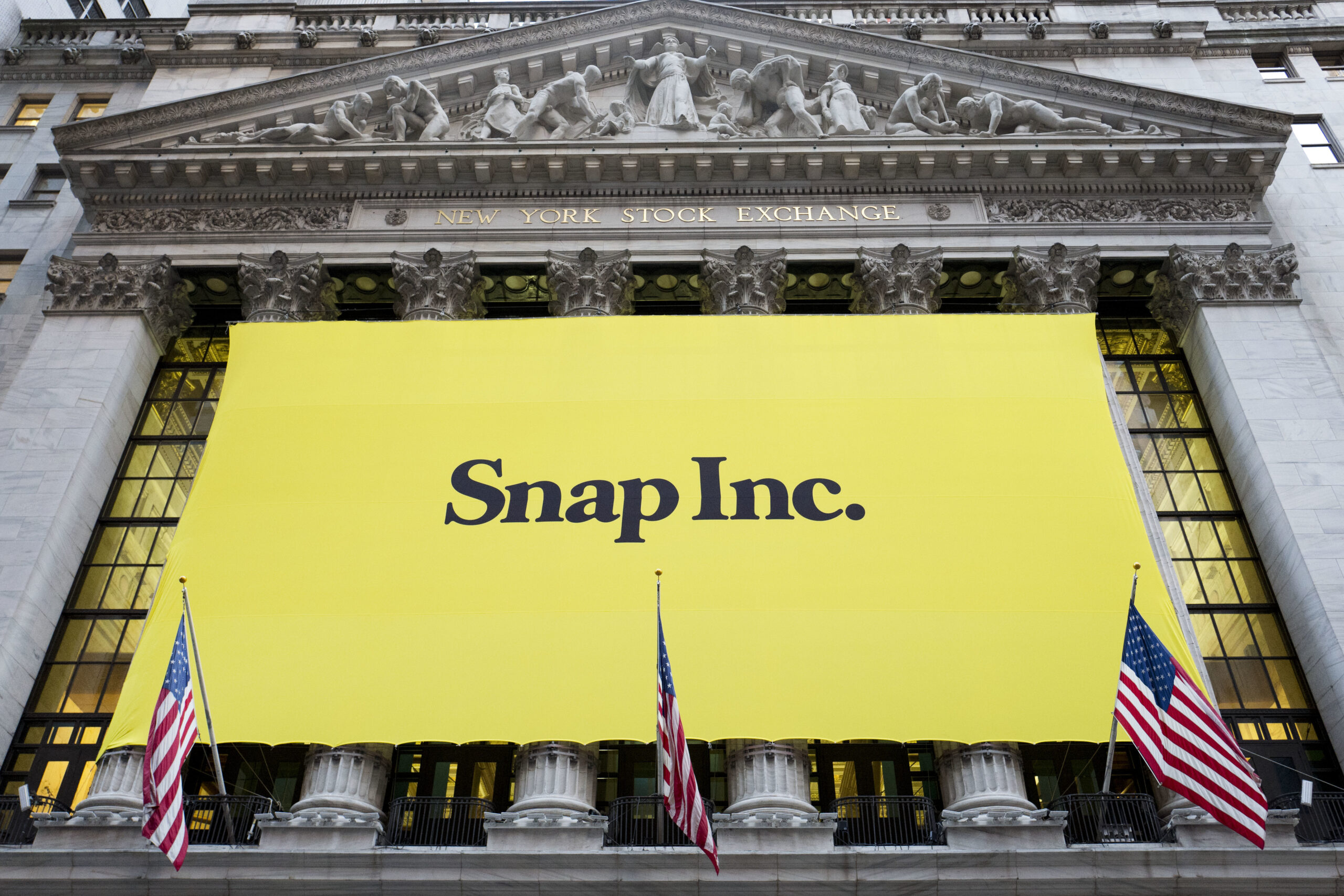 A banner for Snap Inc. hangs from the front of the New York Stock Exchange, Thursday, March 2, 2017, in New York. The company behind the popular messaging app Snapchat is expected to start trading Thursday after a better-than-expected stock offering. (AP Photo/Mark Lennihan) (AP)