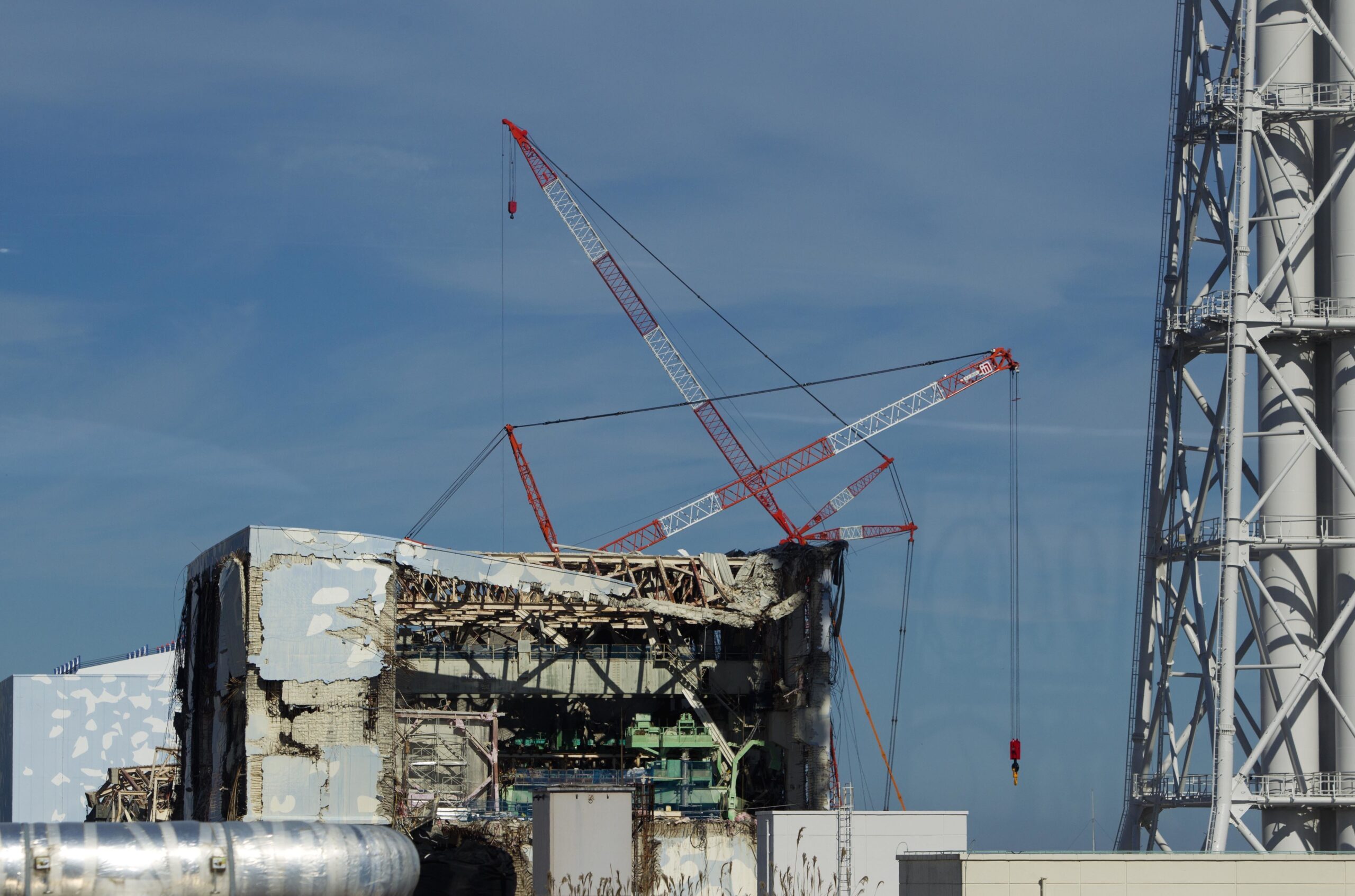 In this Nov. 12, 2011, file photo, the Unit 4 reactor building of the crippled Fukushima Dai-ichi nuclear power station is seen through a bus window in Okuma, Japan. (AP Photo/David Guttenfelder, Pool, File)