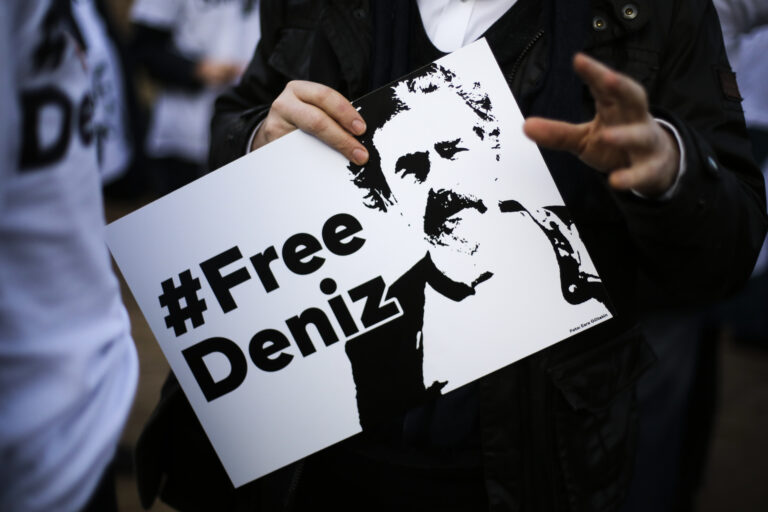 A man holds a poster with the slogan '#FREEDENIZ' during a protest in front of the Turkish embassy in Berlin, Tuesday, Feb. 28, 2017. Demonstrators protest against the police custody of Deniz Yucel, a correspondent in Turkey for the German daily newspaper 'Welt'. (AP Photo/Markus Schreiber) (AP)