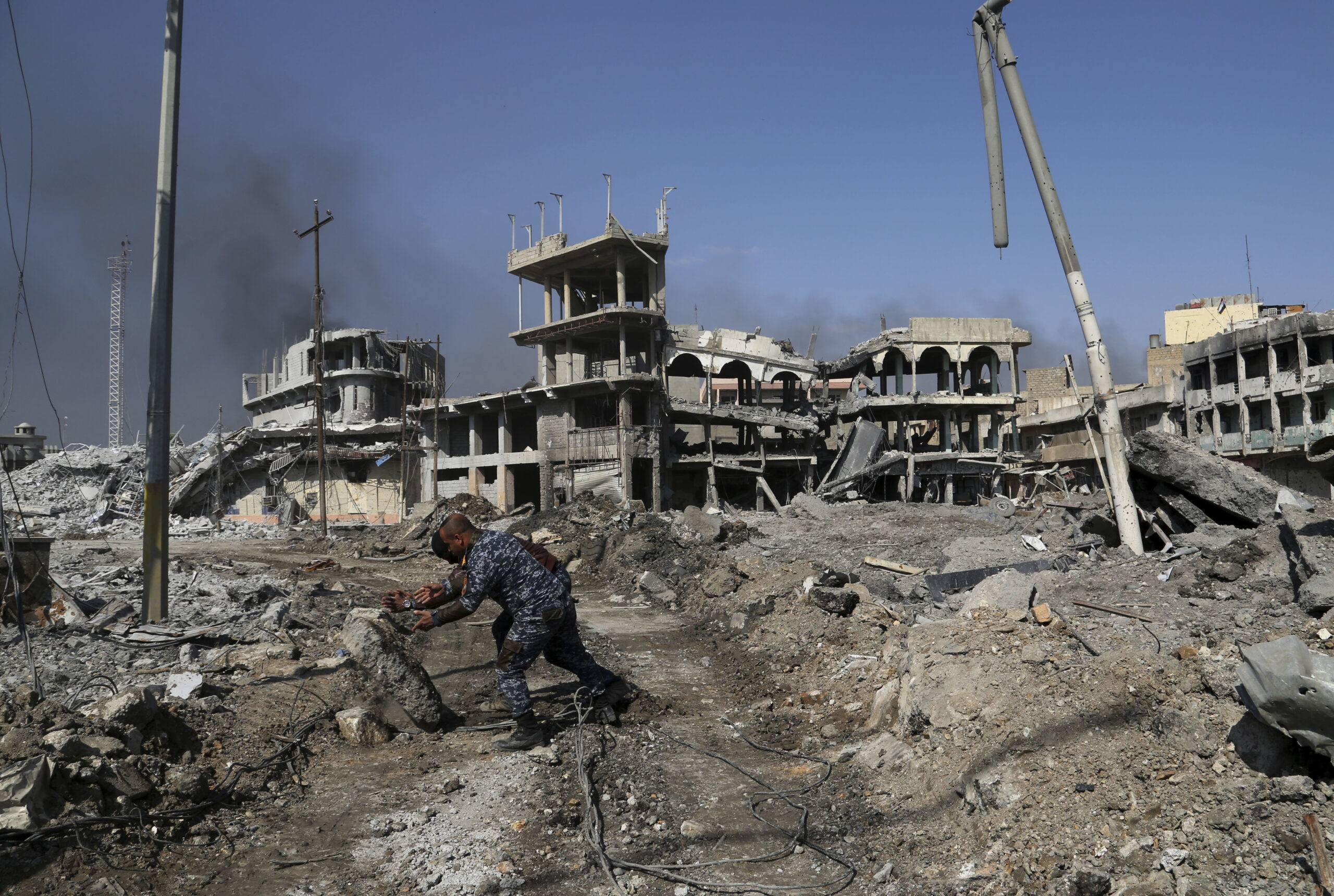 FILE - In this March 7, 2017 file photo, Iraqi federal policemen open the road towards the government complex as Iraqi security forces advance during fighting against Islamic State militants in Dawasa neighborhood in western Mosul, Iraq. (AP Photo/Khalid Mohammed, File) (AP)