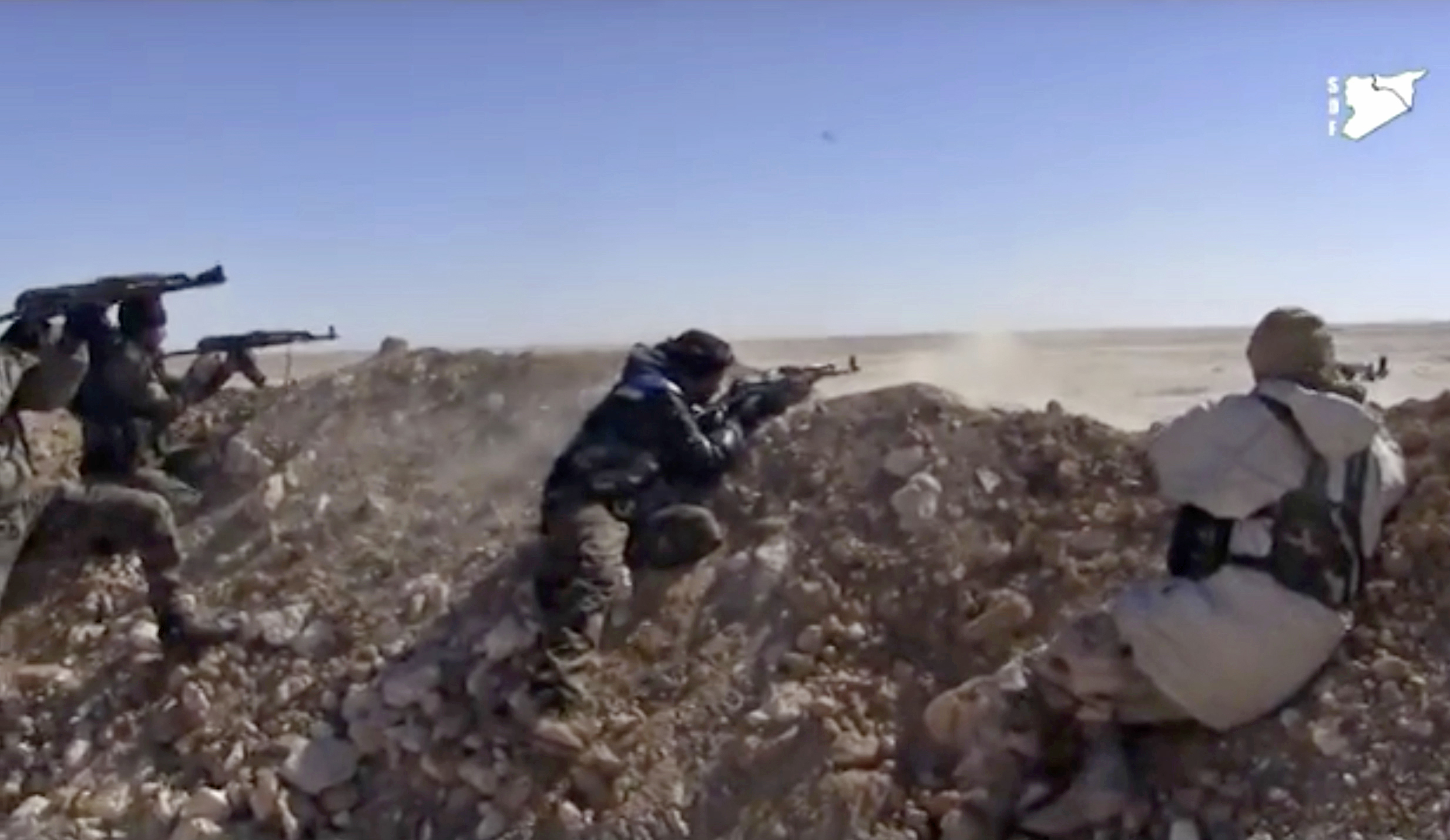 FILE - This frame grab from a  March 6, 2017 video provided by the Syria Democratic Forces (SDF), shows fighters from the SDF opening fire on a position of the Islamic State group in the countryside east of Raqqa, Syria. As the American –backed SDF fighters bear down on Raqqa, the militants have trapped the city’s estimated 300,000 residents to use as human shields, ringing the city with land mines to prevent escape. (Syria Democratic Forces, via AP, File) (AP)