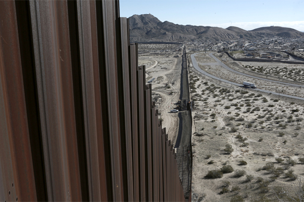 A truck drives near the Mexico-US border fence (AP/Christian Torres)