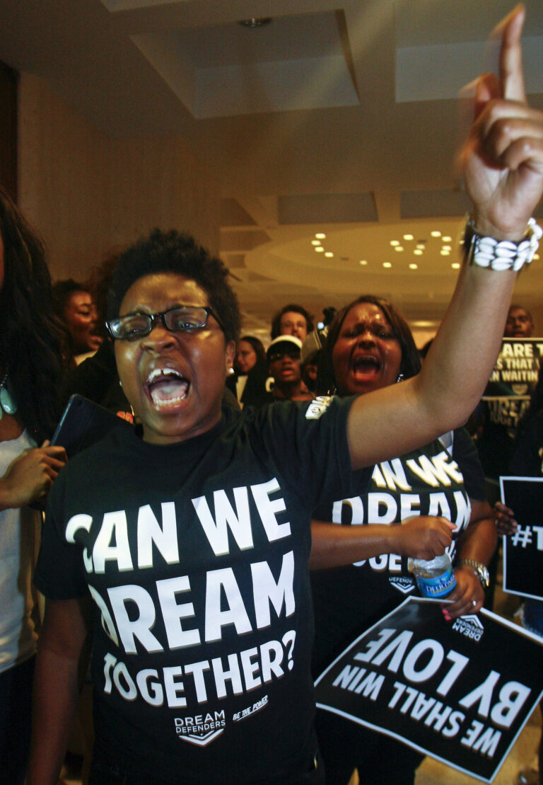 FILE – In this July 26, 2013, file photo, Charlene Carruthers, representing the Black Youth Project 100 in Chicago, protests outside Florida Gov. Rick Scott's office at the Capitol in Tallahassee, Fla. A cluster of Black Lives Matter groups, including the Black Youth Project 100, and an organization leading the push for a $15-an-hour wage, Fight for $15, are joining forces for their first national joint action, planning "Fight Racism, Raise Pay" protests on the 49th anniversary of the Rev. Martin Luther King Jr.'s assassination, April 4, 2017, in two dozen cities including Chicago. (AP Photo/Phil Sears, File) (AP)