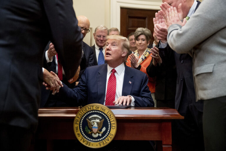President Donald Trump signs the Waters of the United States (WOTUS) executive order, Tuesday, Feb. 28, 2017. (AP Photo/Andrew Harnik)
